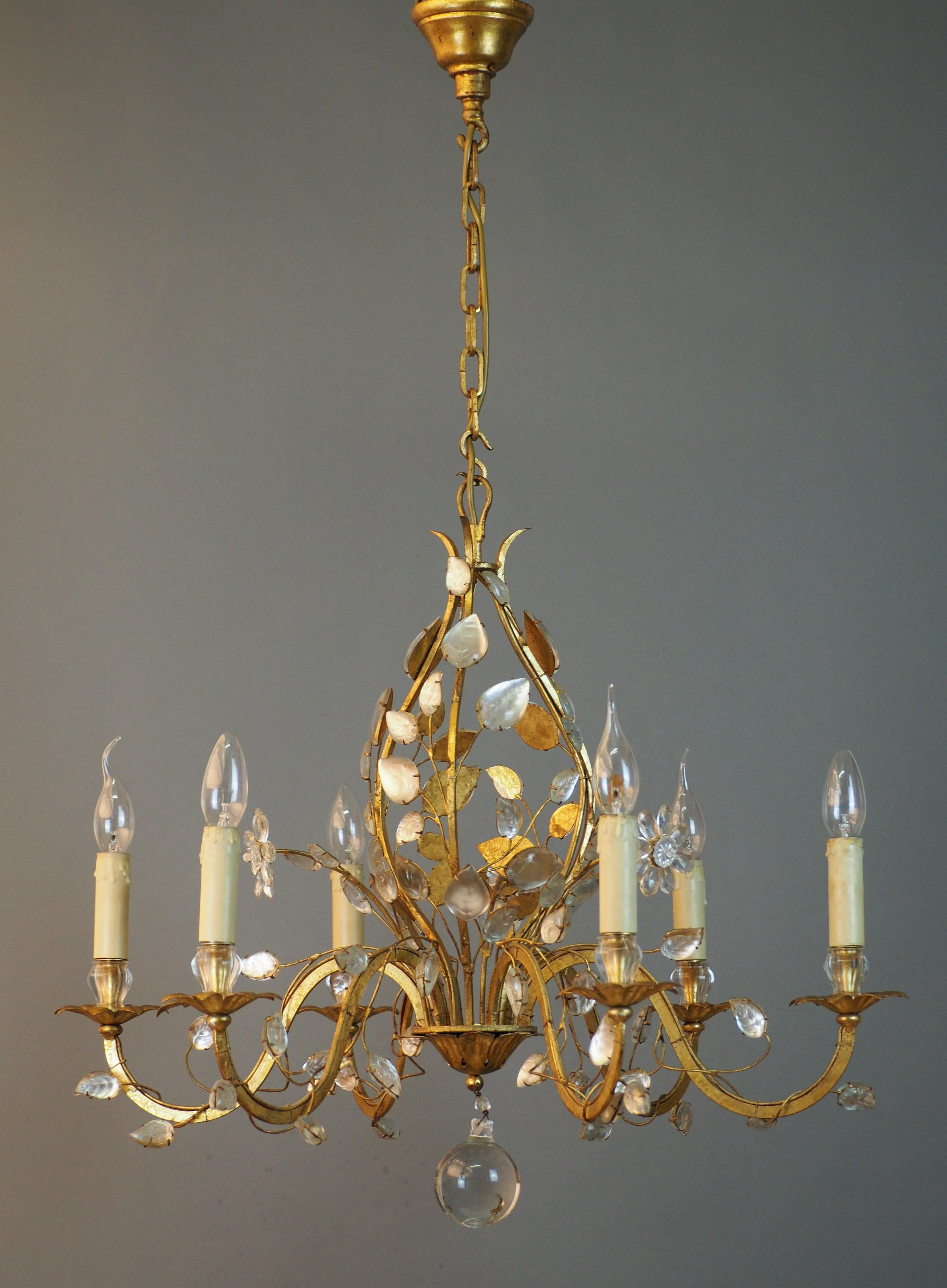 A wonderful six-arm gilt iron and crystal flower chandelier by Maison Baguès, Paris, circa 1950s.

Socket: 6 x e14 for standard screw bulbs.

The dimensions of the fixture only are 26.77 x 23.62, totally height is 39.37

The condition is