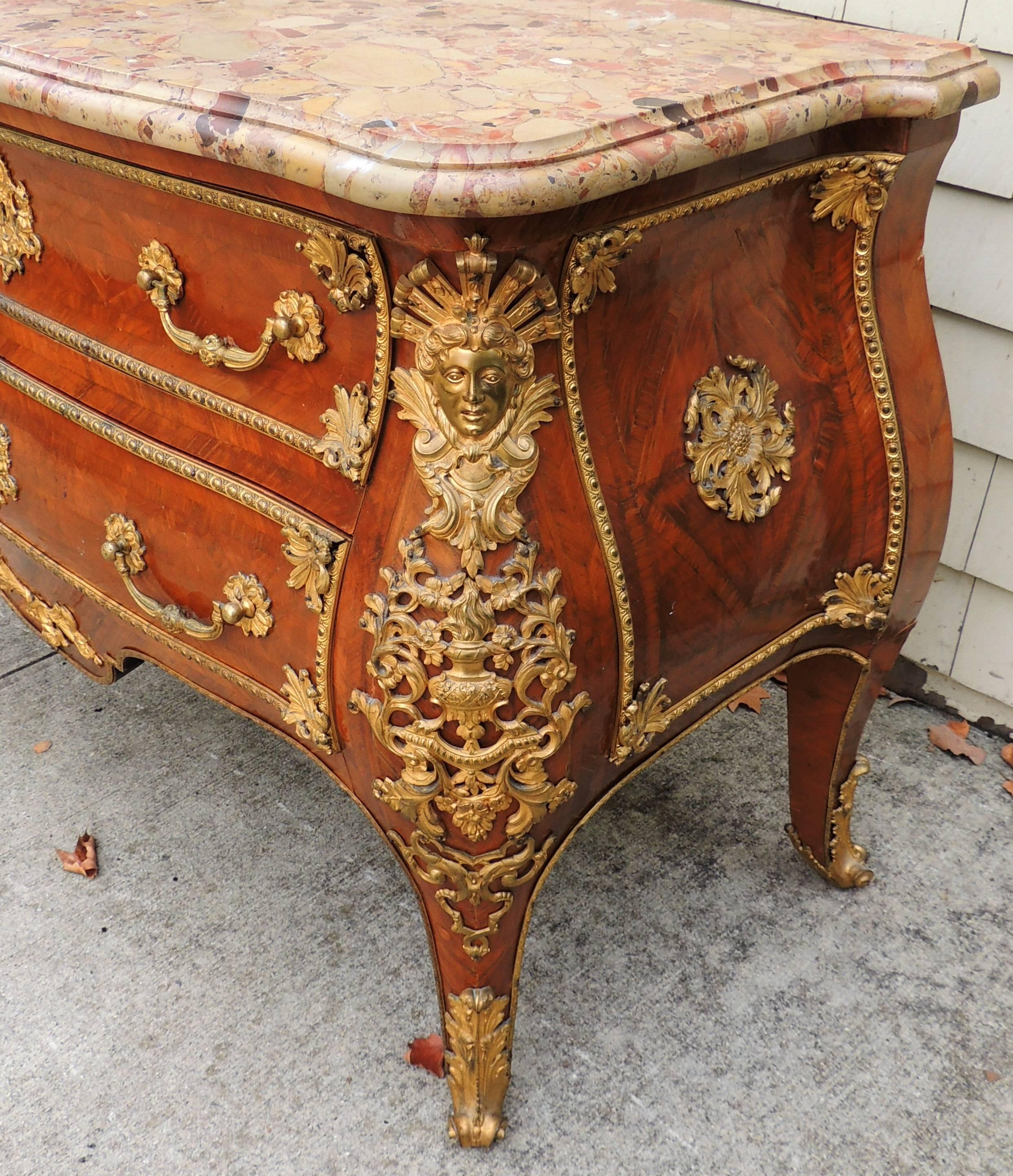 A wonderful late 19th century Louis XV style two-drawer commode or chest with doré bronze ormolu-mounted, tulip and kingwood parquetry and original marble-top.
Measurements: 36.5