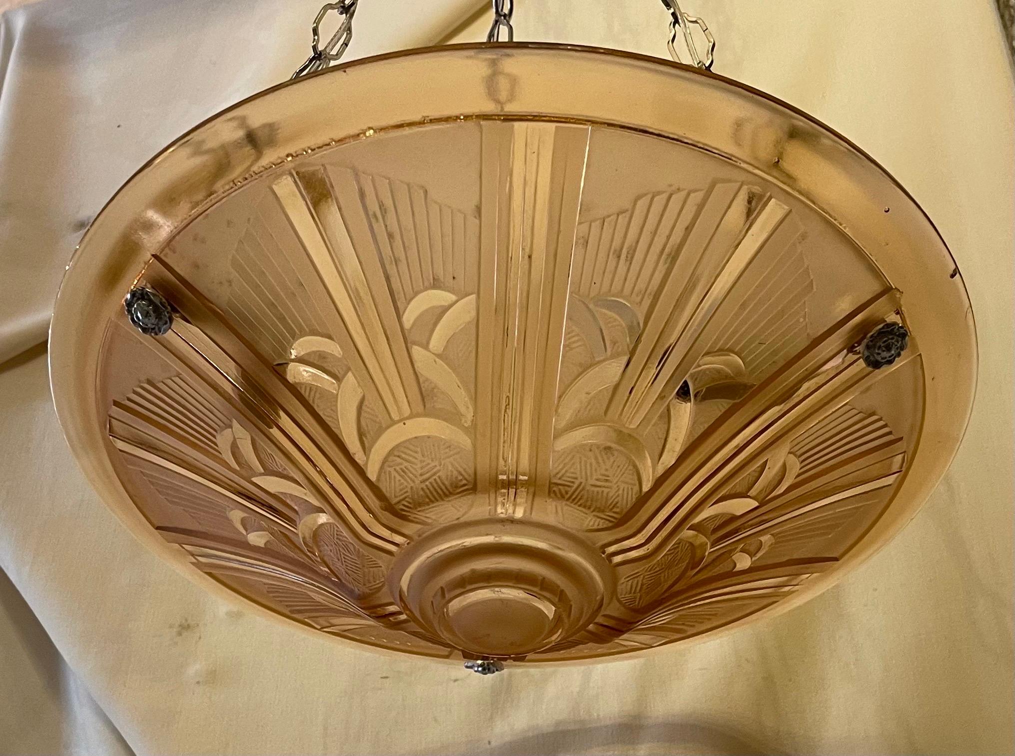 A Wonderful French Art Deco Chandelier In The Manner Of Dugué With A Pink / Peach Art Glass And Nickel Finishes This Semi Flush Fixtures Height Can Be Adjusted By Adding Or Removing Chain
Completely Rewired With 3 New Candelabra Sockets