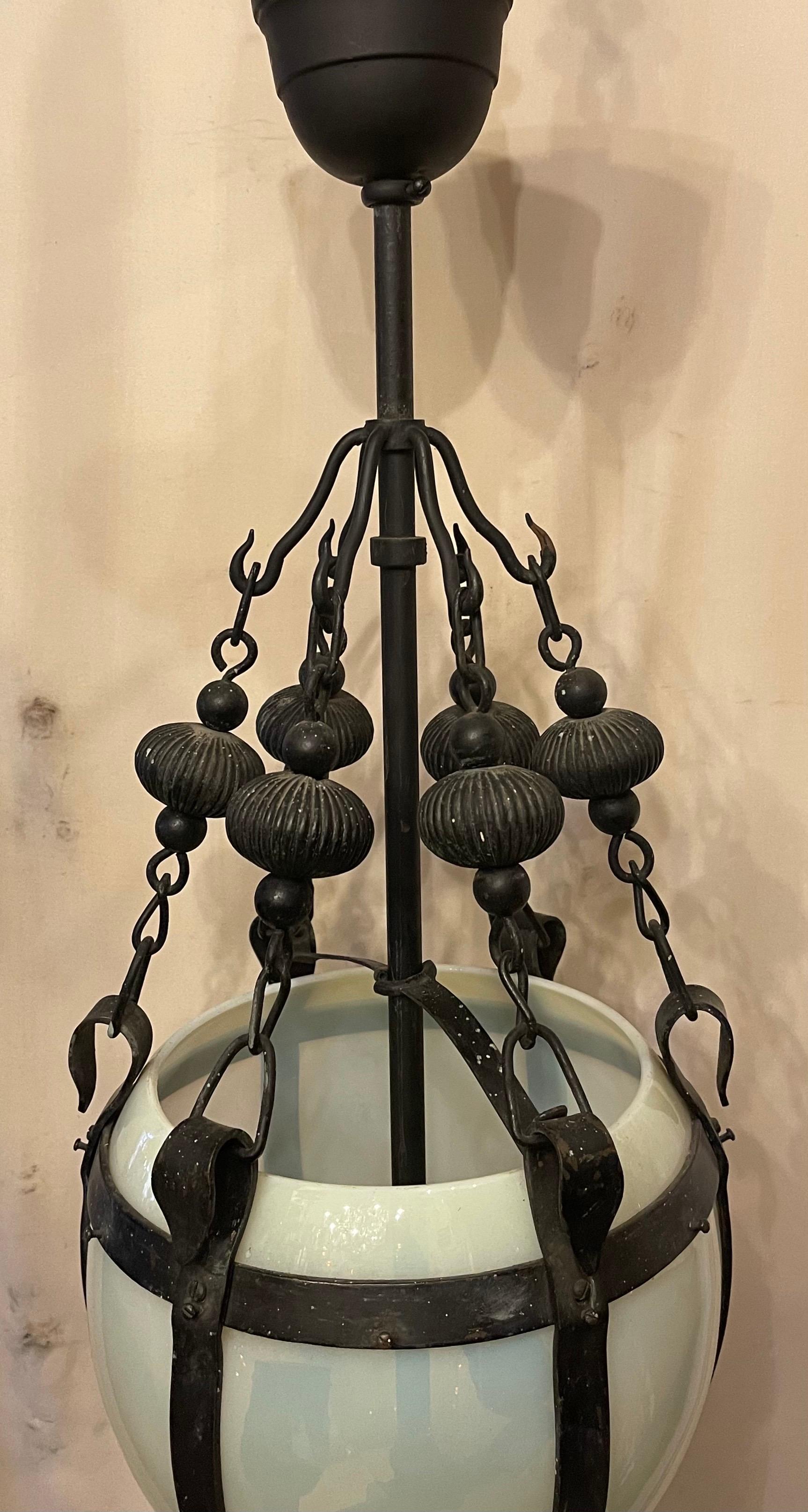 A wonderful French Art Deco opaline glass and wrought iron lantern pendant light fixture with 2 Edison sockets.