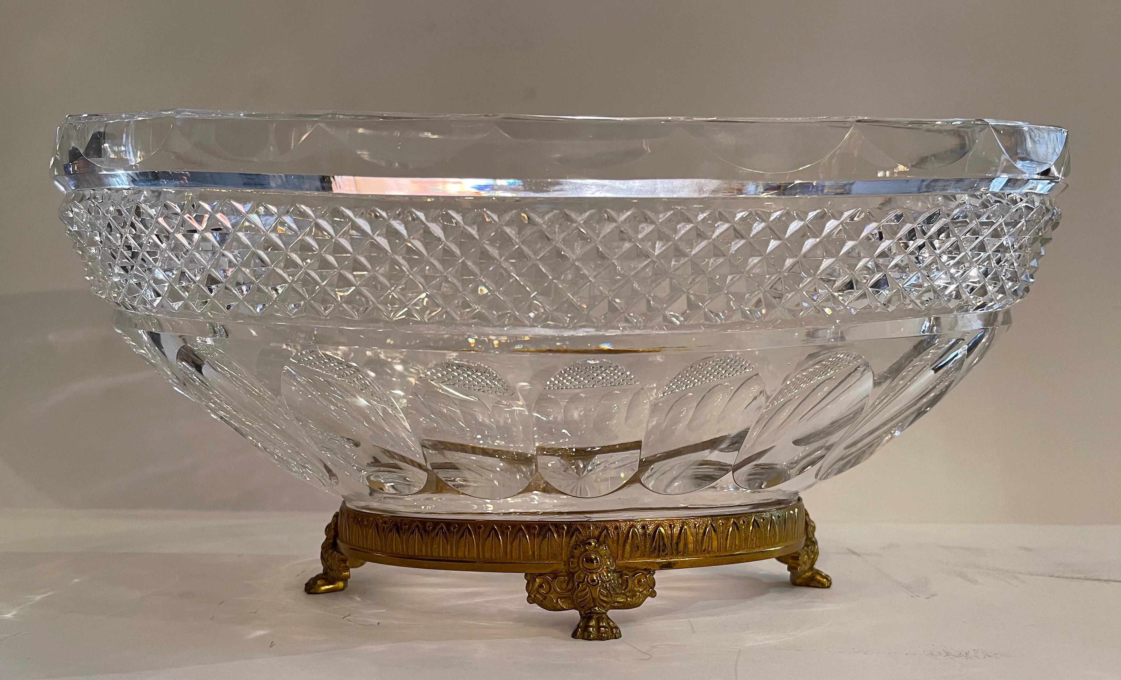 A wonderful large French gilt bronze paw foot and diamond cut crystal oval centerpiece in the manner of Baccarat.