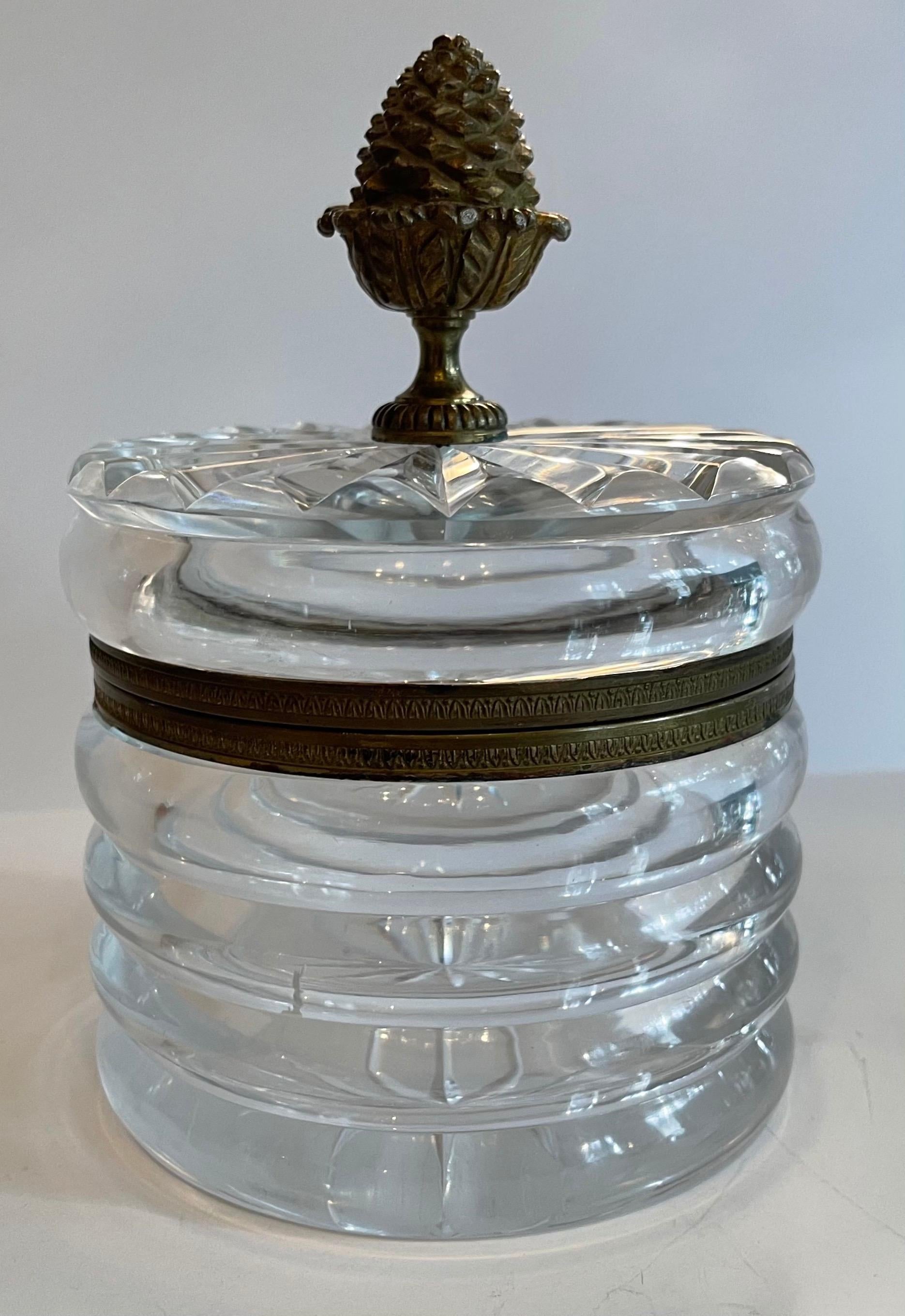 A wonderful round Baccarat style doré bronze and cut crystal casket jewelry box with acorn finial handle and hinged top.

Measures: 5