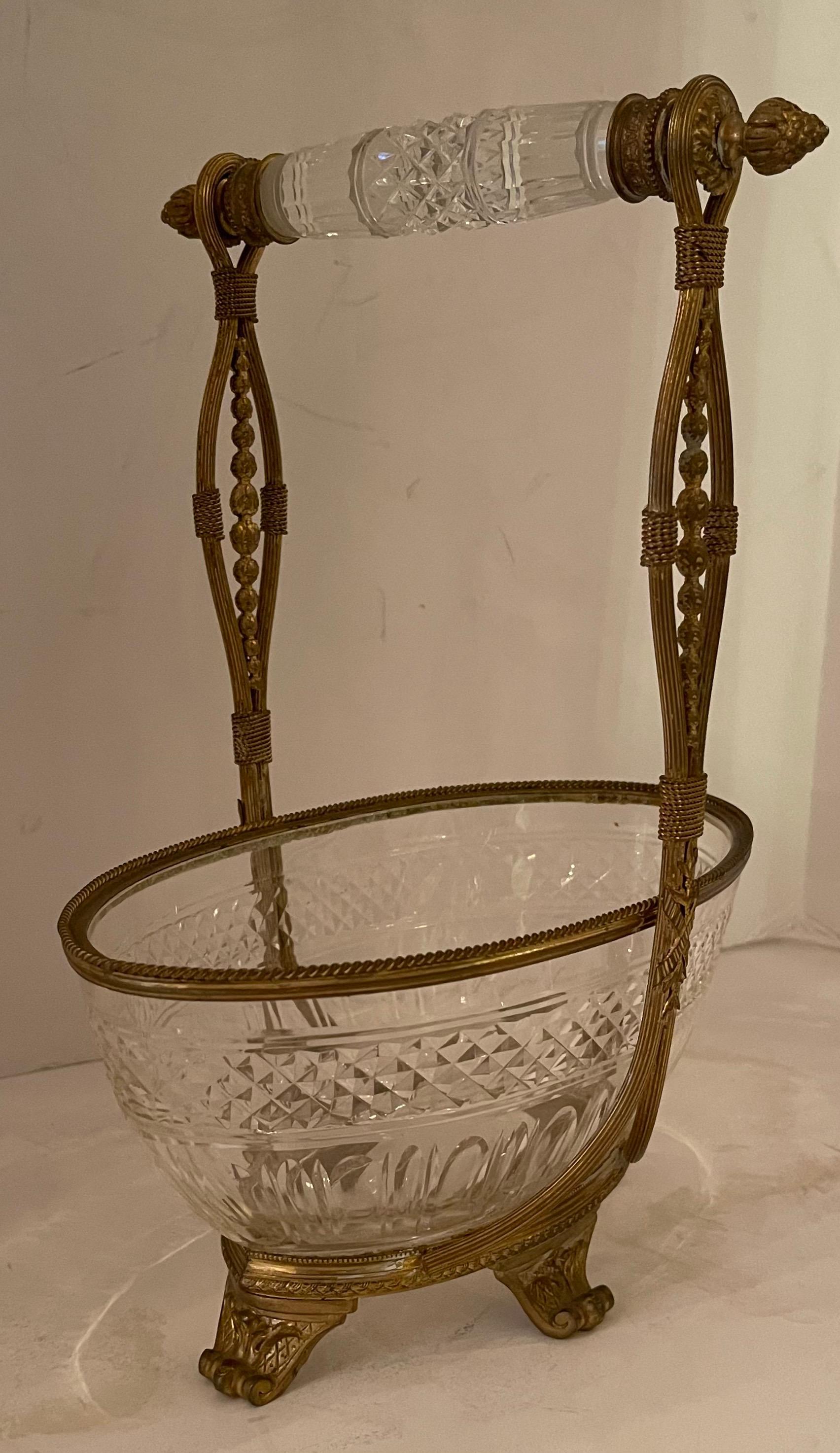 A wonderful french dore bronze & cut crystal oval basket centerpiece with pierced open work handle resting on four legs.
In the manner of Baccarat.