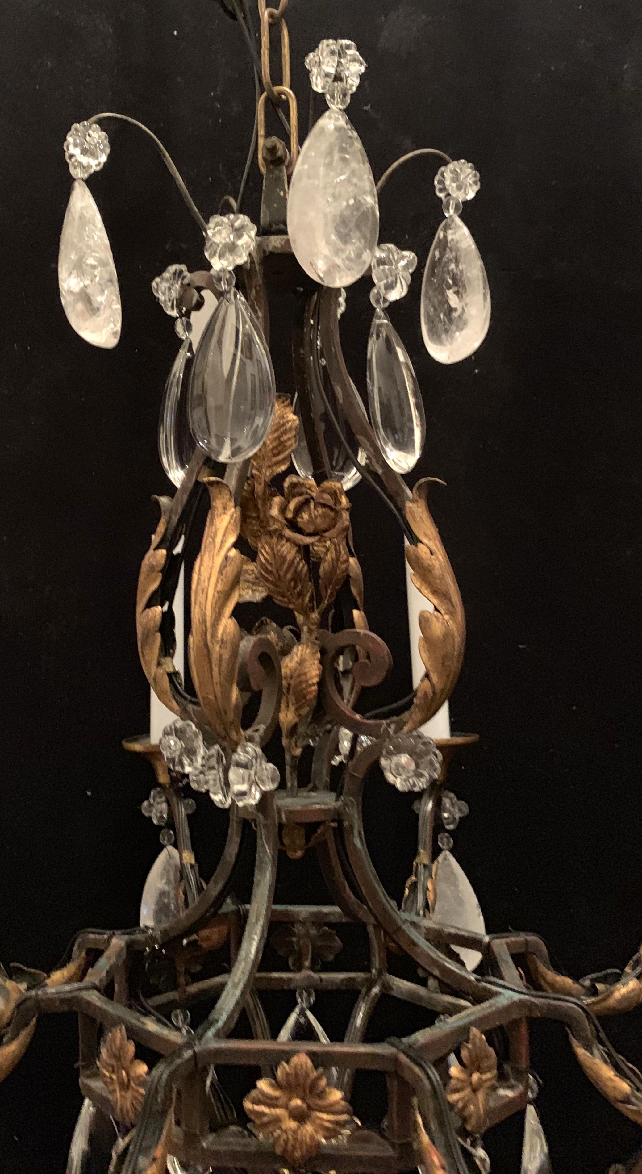 A wonderful French rock crystal and gilt iron flower and leaf bouquet chandelier in the manner of Bagues.