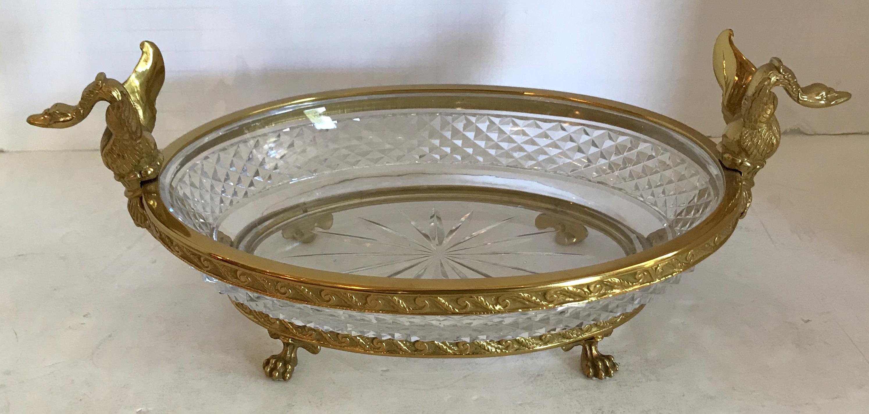 A wonderful French bronze and diamond cut crystal oval centerpiece with swan ormolu handles on paw feet.