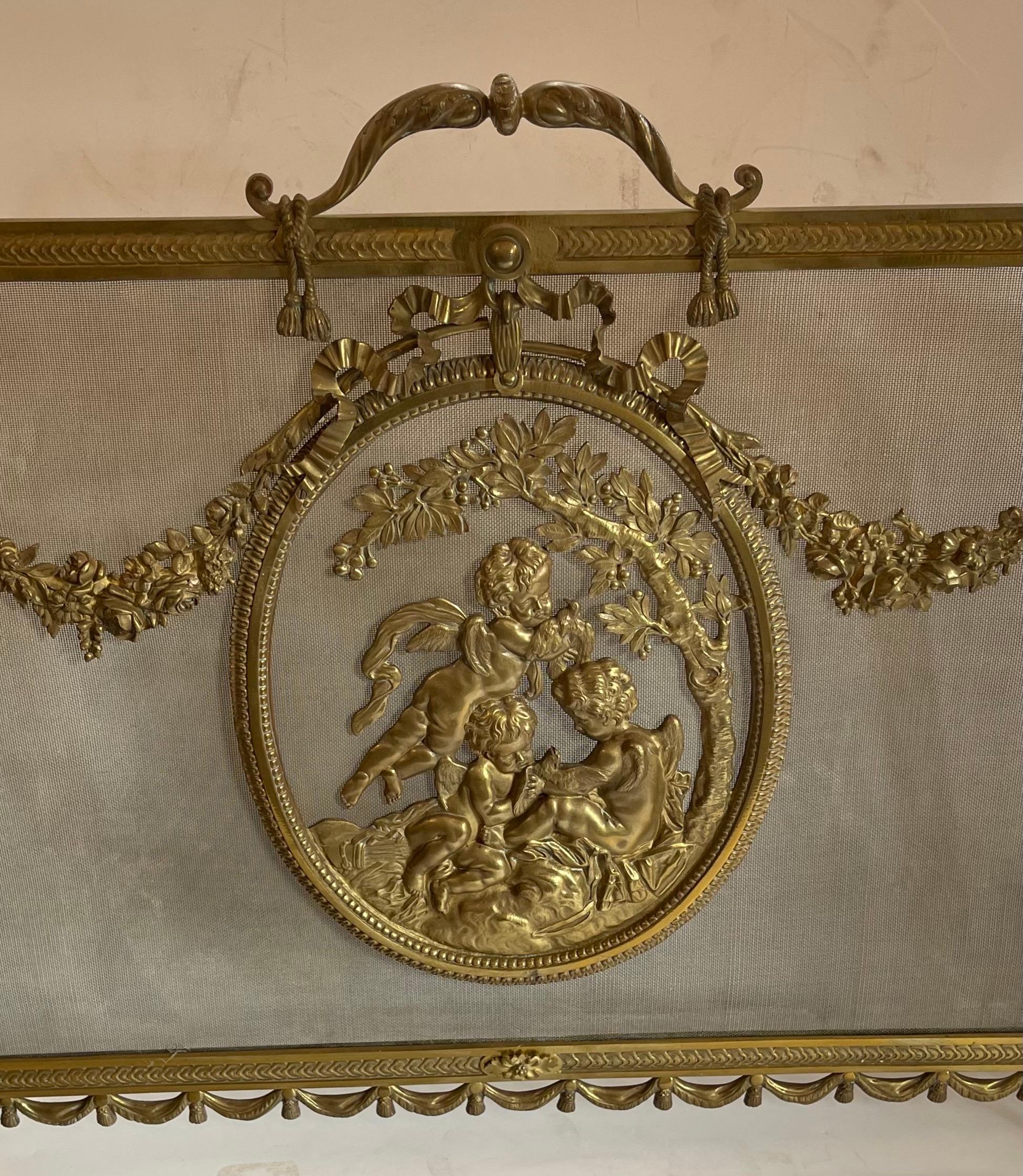 A wonderful French Cherub Medallion 19th century Louis XV style gilt-bronze with garland bow & swag fireplace screen.