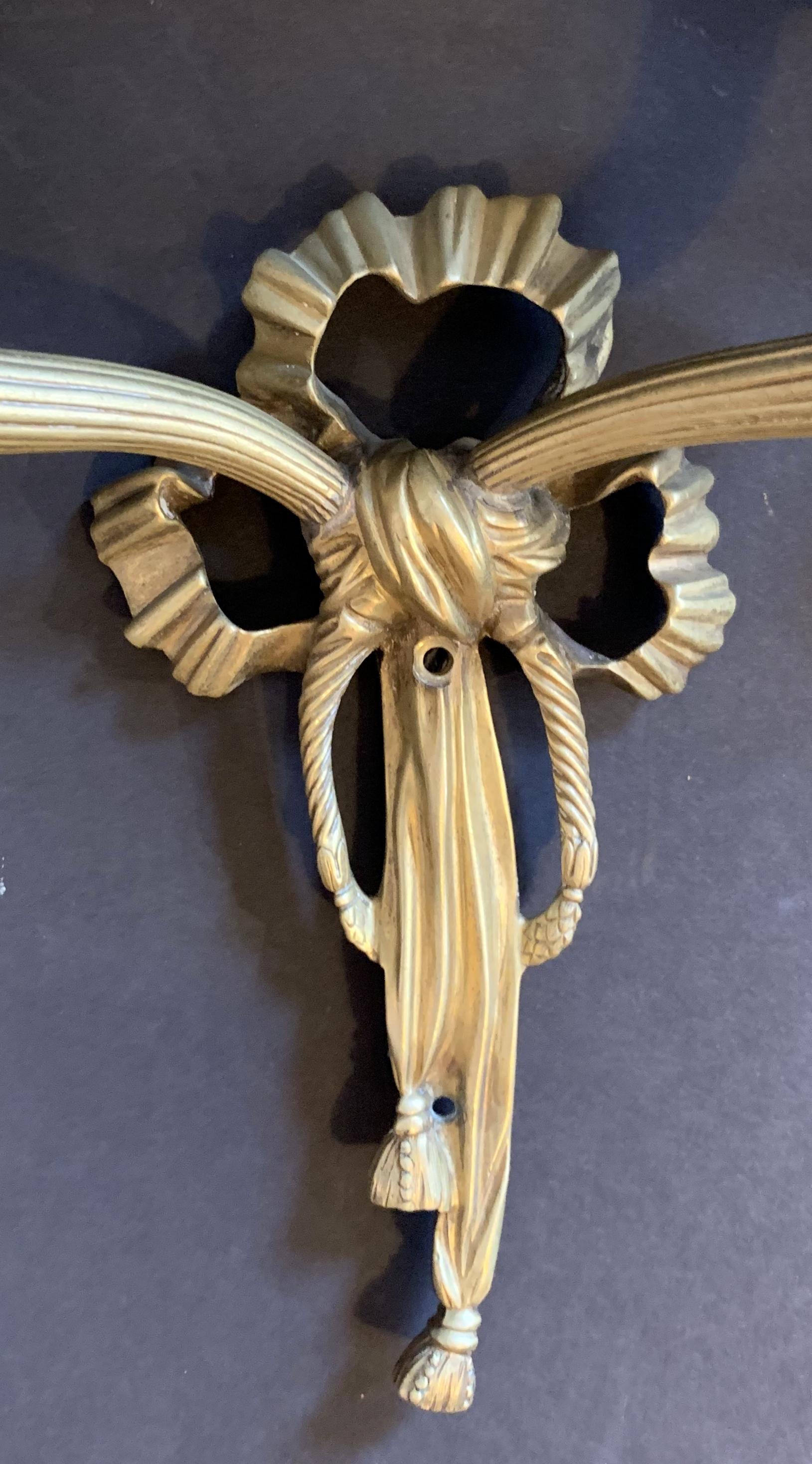 Belle Époque Wonderful French Dore Bronze Pair Caldwell Ribbon Tassel Two-Arm Sconces For Sale