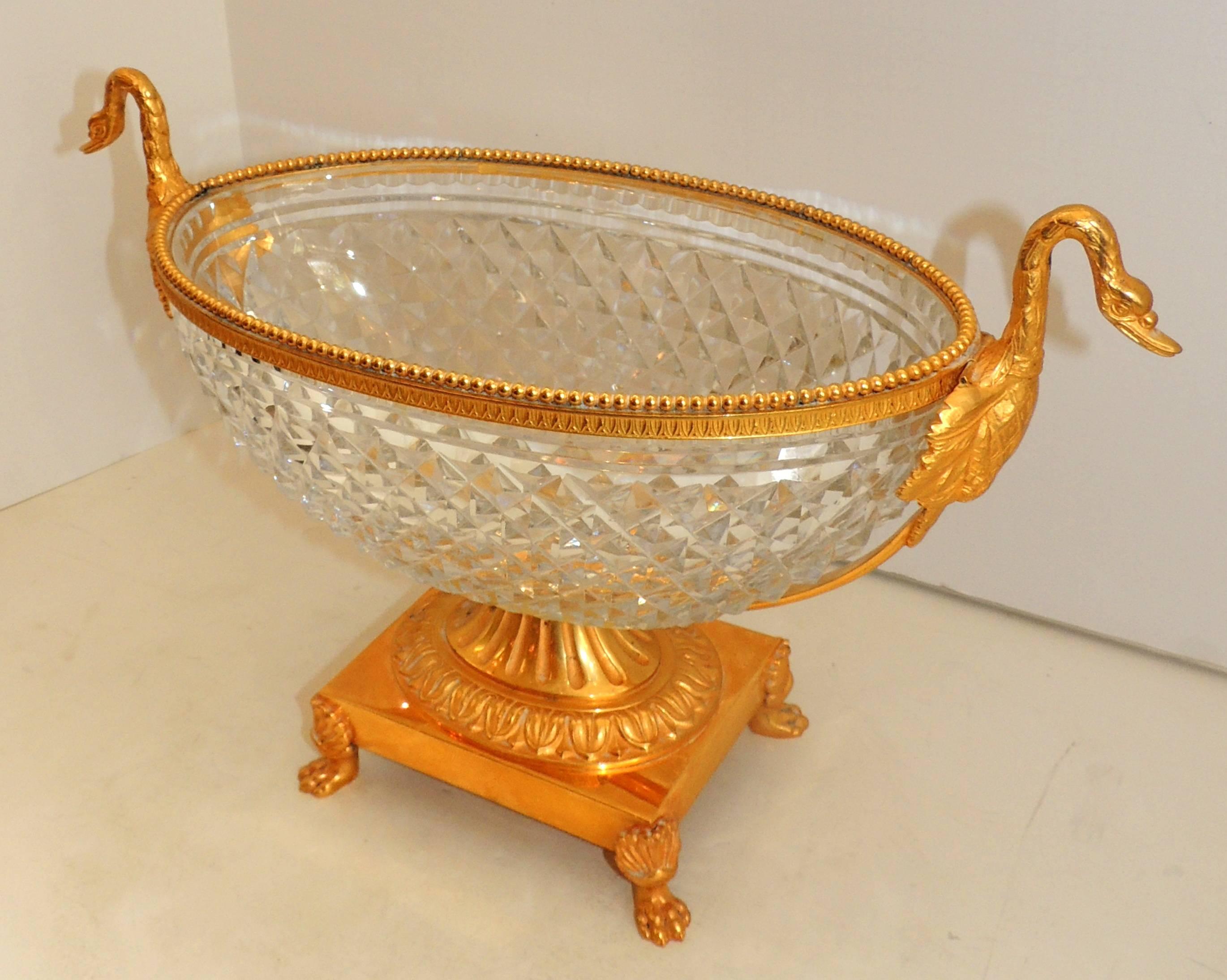 A wonderful French neoclassical motif gilt doré bronze centrepiece with swan handles set in a cut crystal bowl.
This is a very stately and impressive elegant centerpiece, with very fine detail.