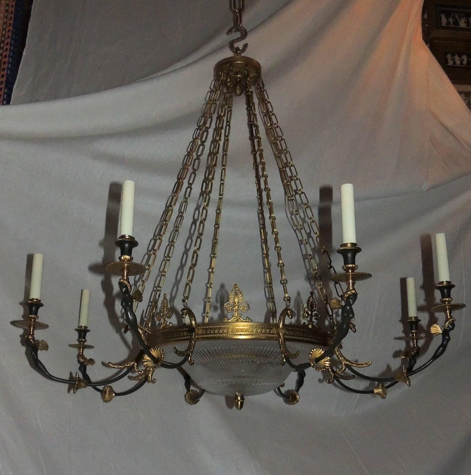 A wonderful French doré and patina bronze cut crystal figural Empire neoclassical large chandelier. Measures: 36