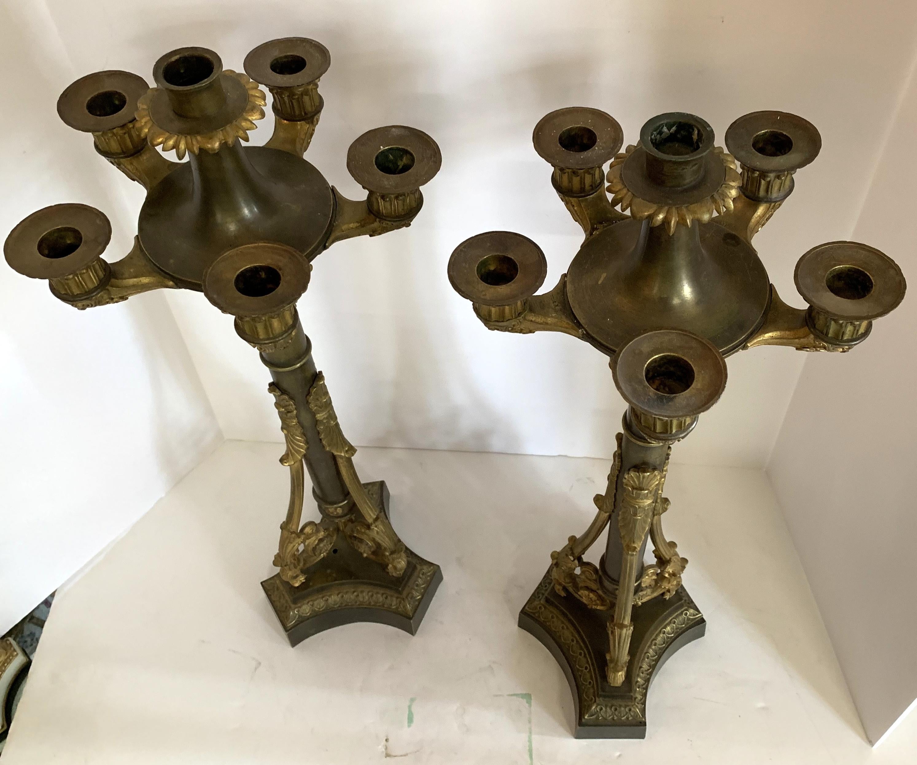 A wonderful French Empire / neoclassical bronze two-tone pair of fine candelabras.