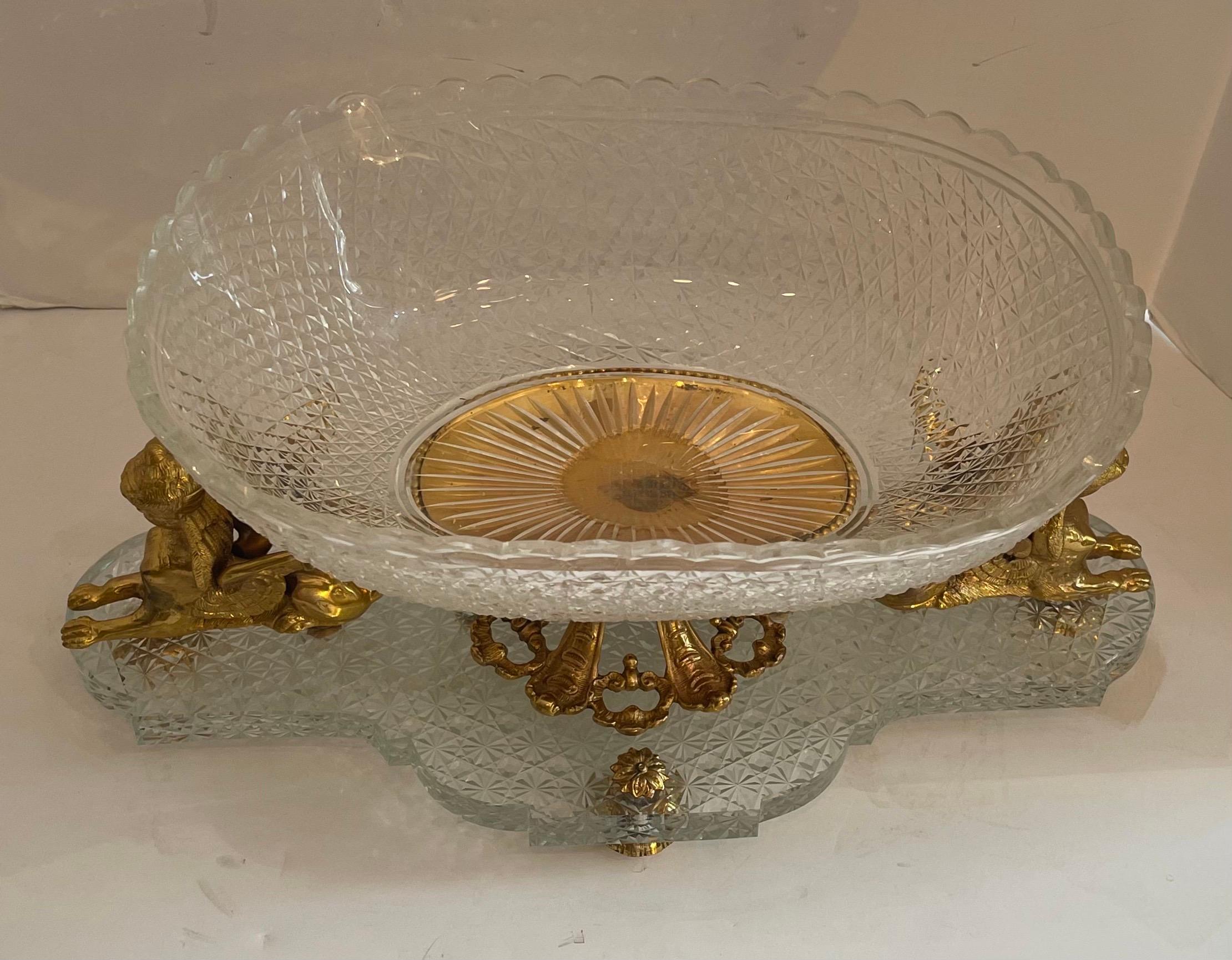 A Wonderful French Empire Baccarat style centerpiece with cut crystal central bowl supported on bronze basket stamped Baccarat France And Flanked by two female Sphinx figures and raised on bronze cushion feet.