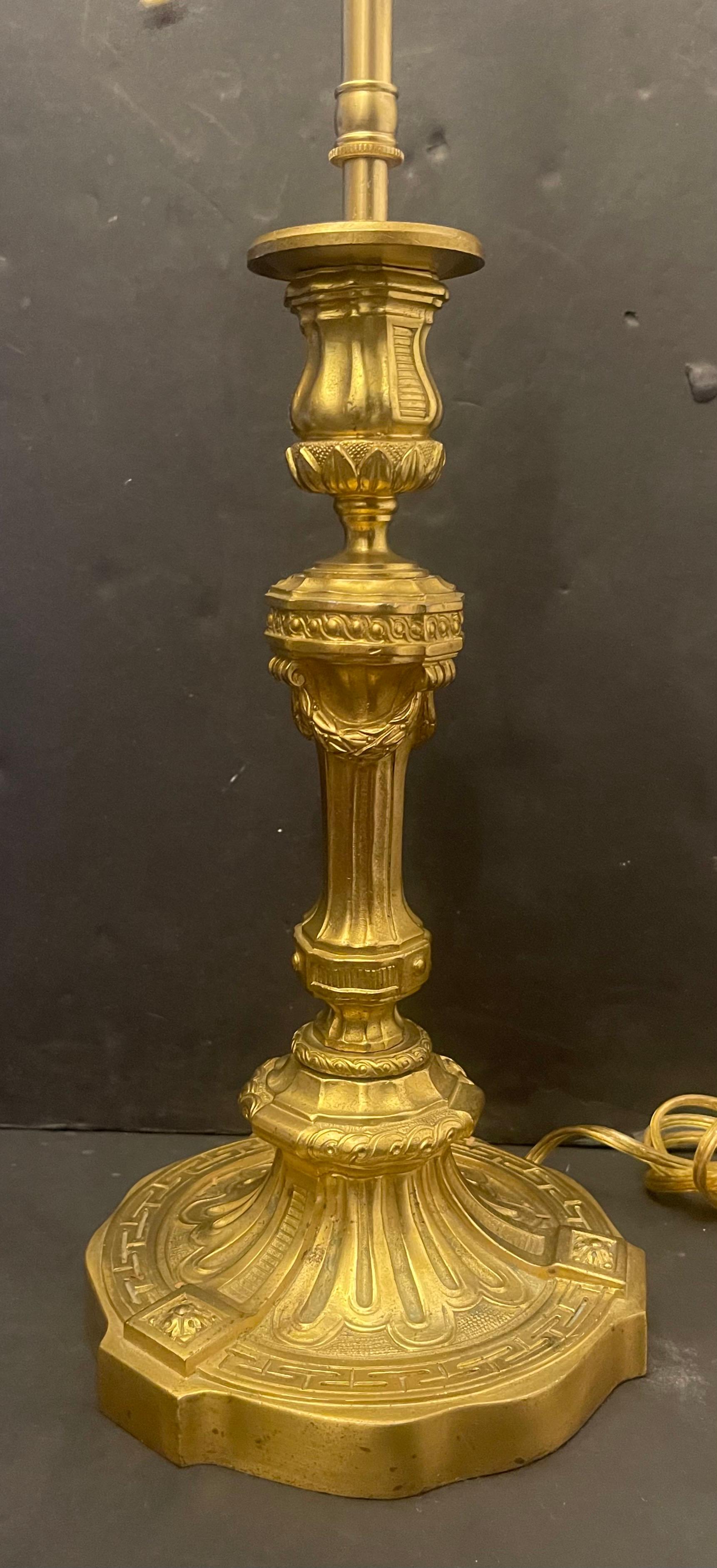 A wonderful French empire gilt doré bronze neoclassical candlestick pair of lamp, rewired and ready to enjoy.