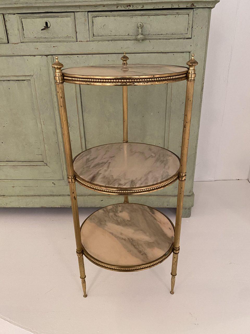 Beautiful and tall side table / étagère, with three round marble shelves, from circa 1940s-50s France. Elegantly made with a sophisticated sleek brass frame with fluted grooved legs and spiers, and with fine beading along the edge of each shelf.