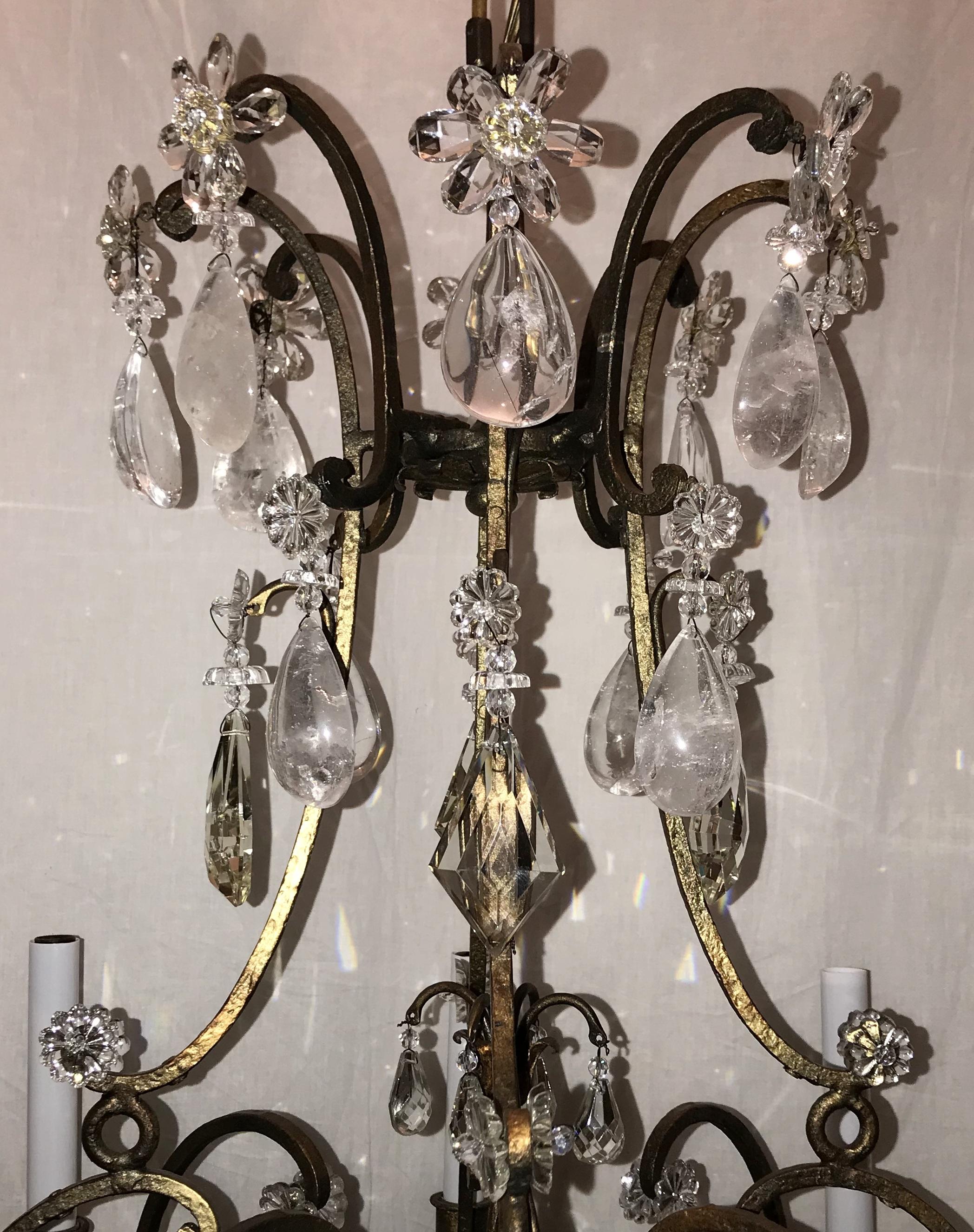 A wonderful French gold gilt and alternating rock crystal bird cage form, center flower bouquet chandelier in the manner of Baguès.