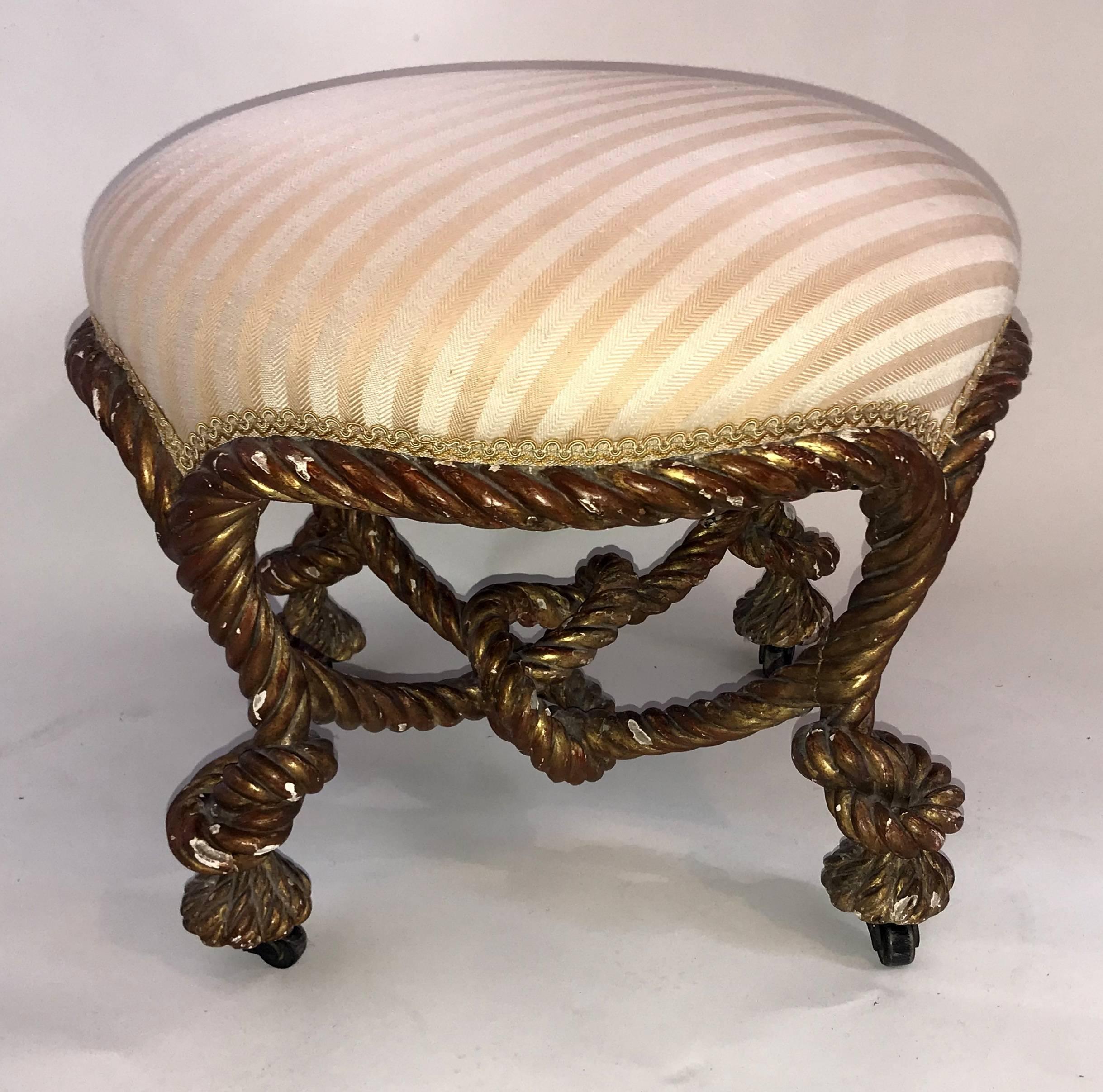 Wonderful French Napoleon III giltwood knotted rope round ottoman / tabouret / pouf silk stripe upholstery on casters.
 