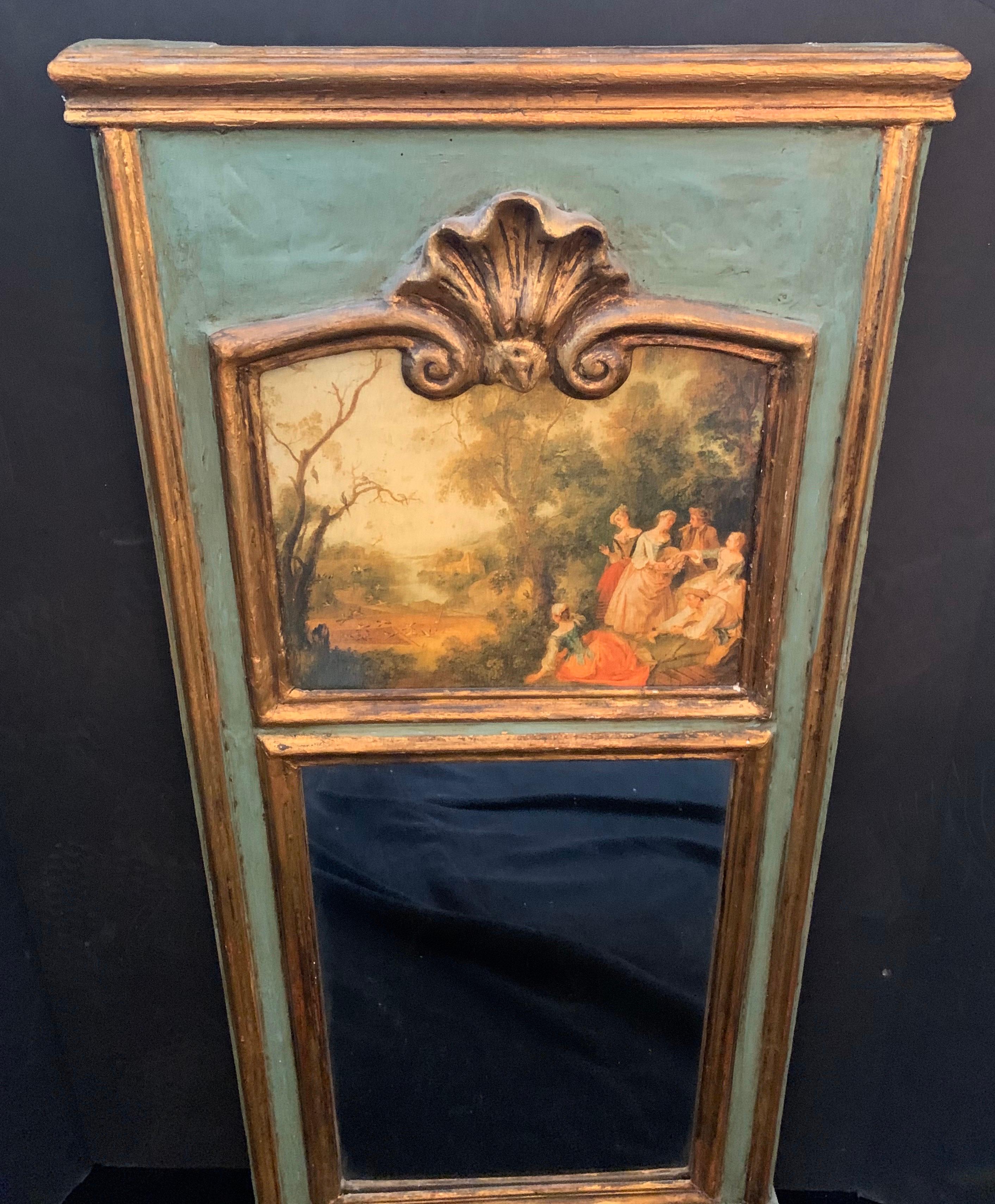 A wonderful French green and gold giltwood trumeau mirror depicting a courting garden landscape scene, makes a charming addition to any space.