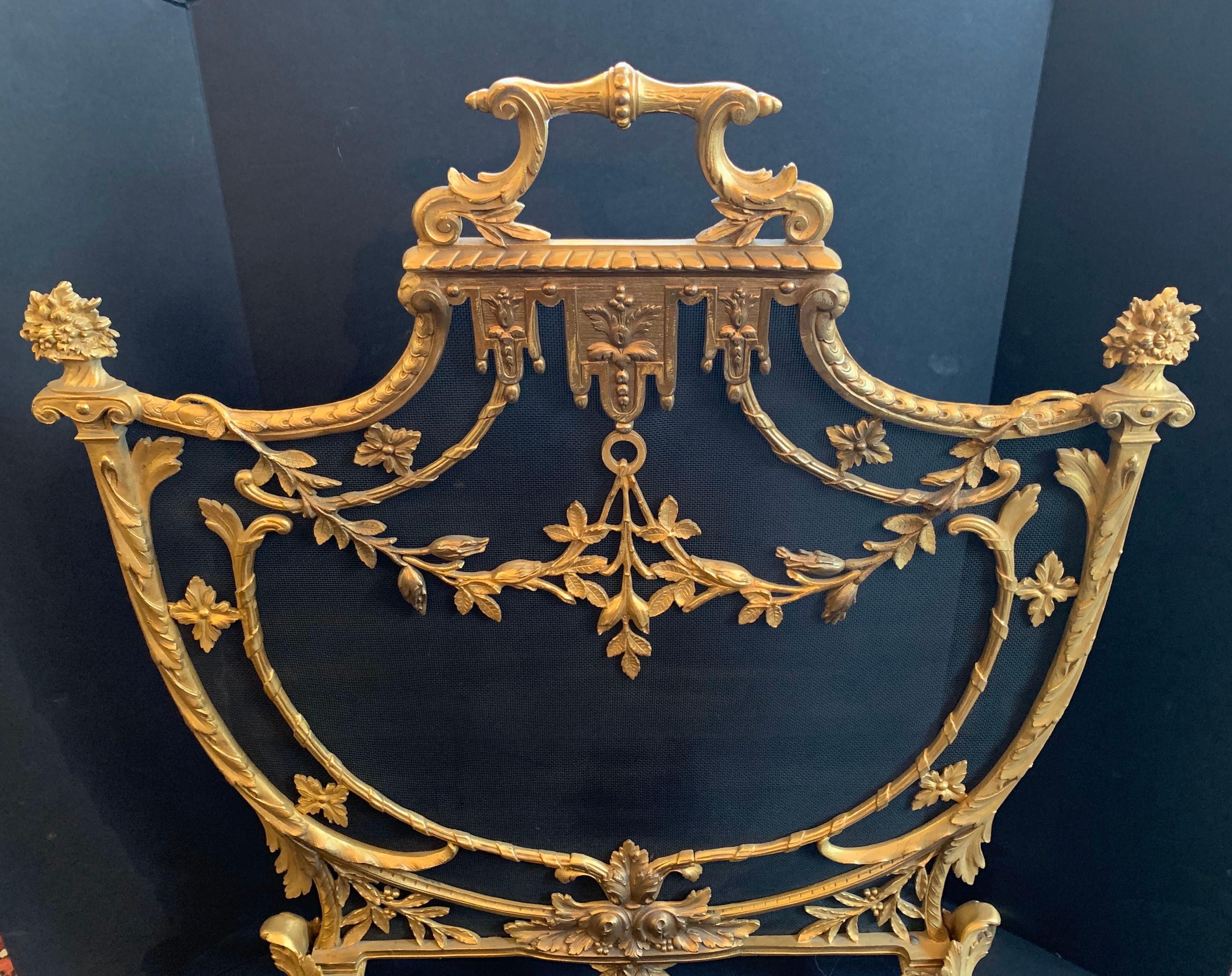 A wonderful French Louis XV style, dore bronze fireplace garland swag shield form screen.
