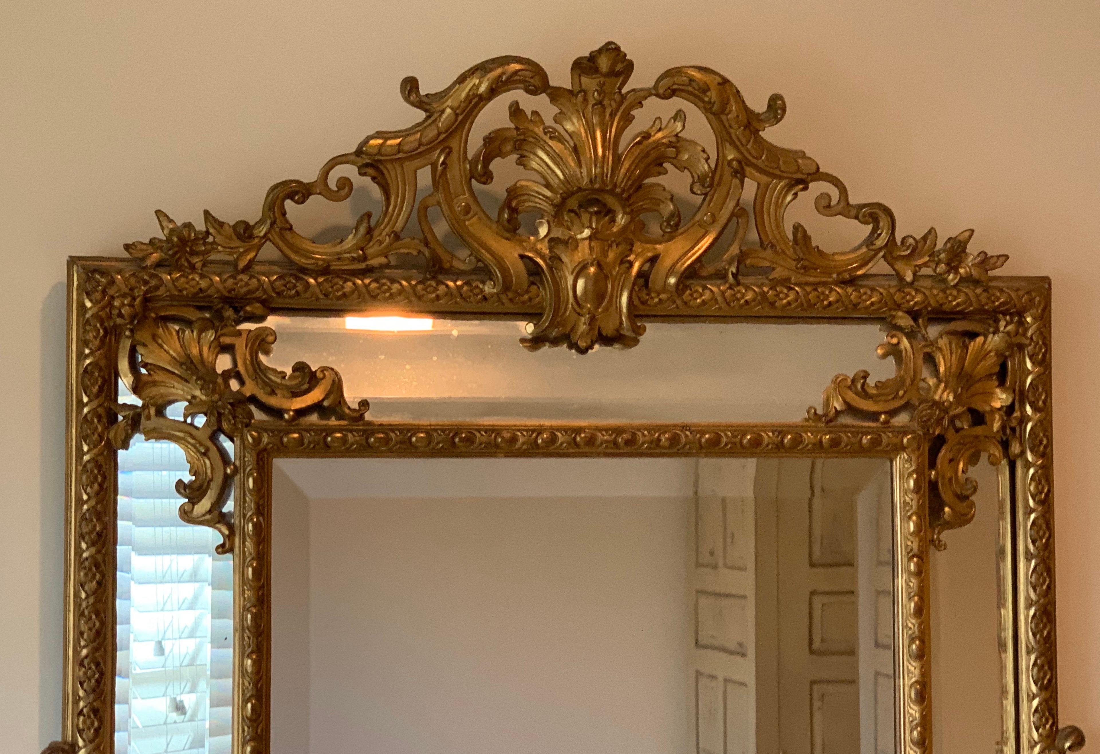 A wonderful French Louis XVI Philippe style cushion wood carved and cold gilt beveled mirror.