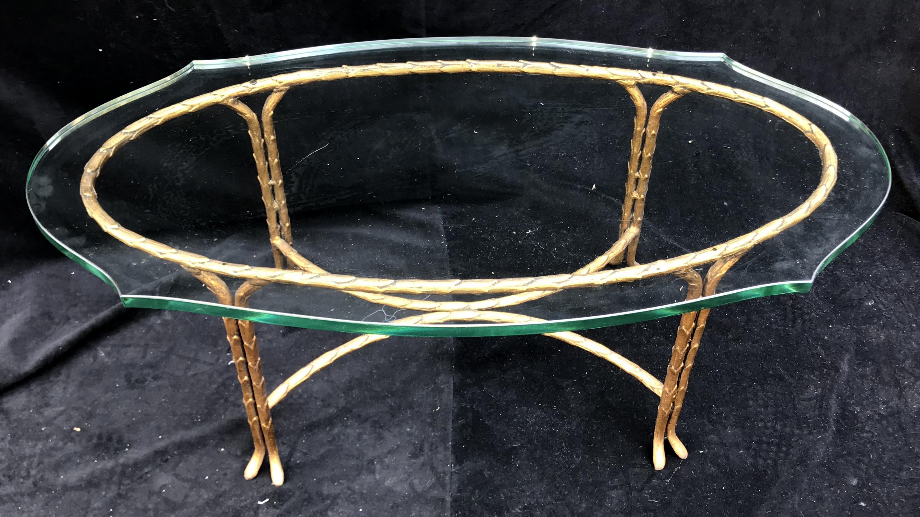 A wonderful French oval Maison Baguès gilt bronze, faux bamboo thick scalloped glass top coffee / cocktail table.