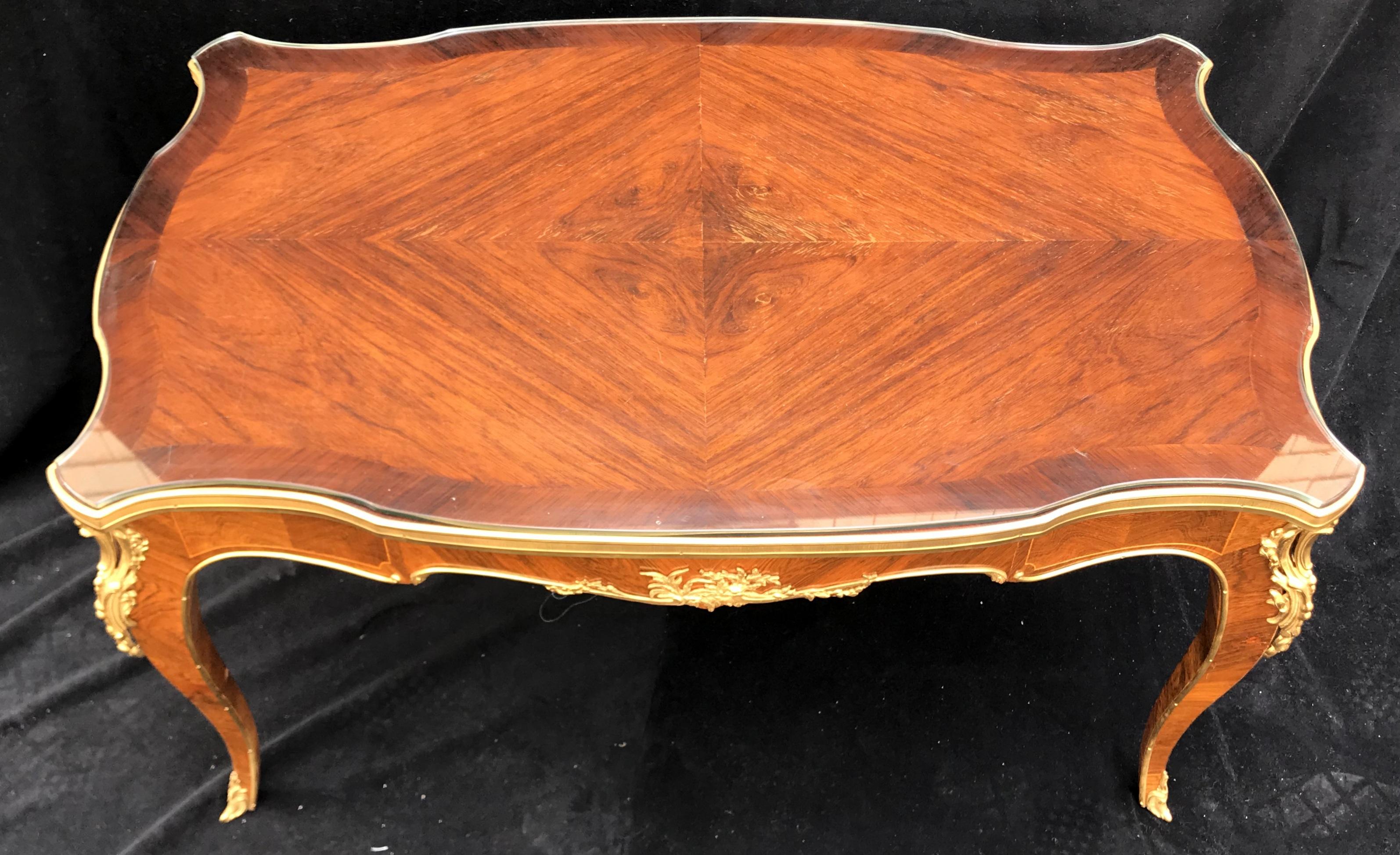 Wonderful French marquetry and bronze ormolu-mounted cocktail or coffee table with glass top.