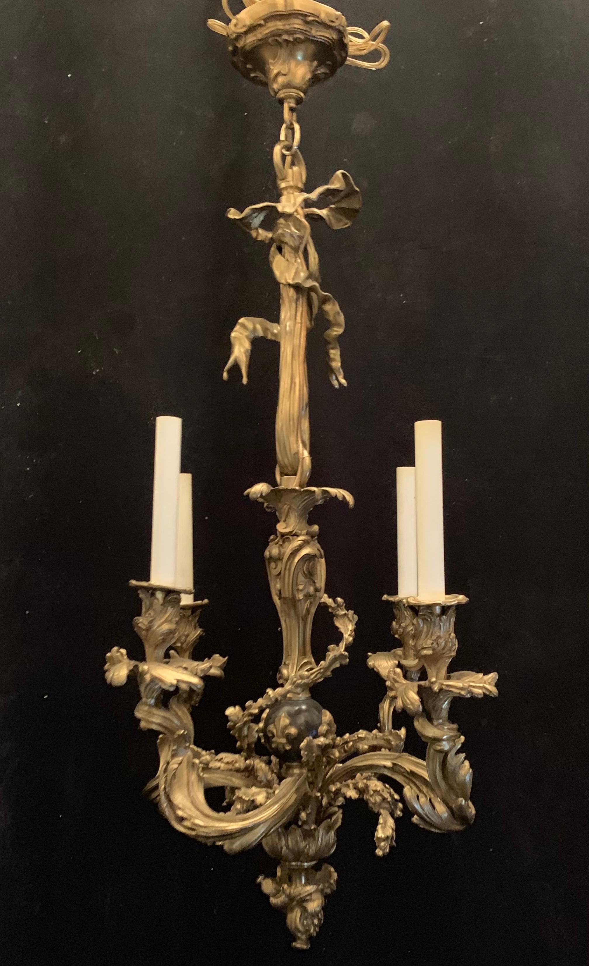 A wonderful French neoclassical gilt bronze and patinated bow / tassel Rococo style 4 candelabra light chandelier with fleur-de-lis appliques.