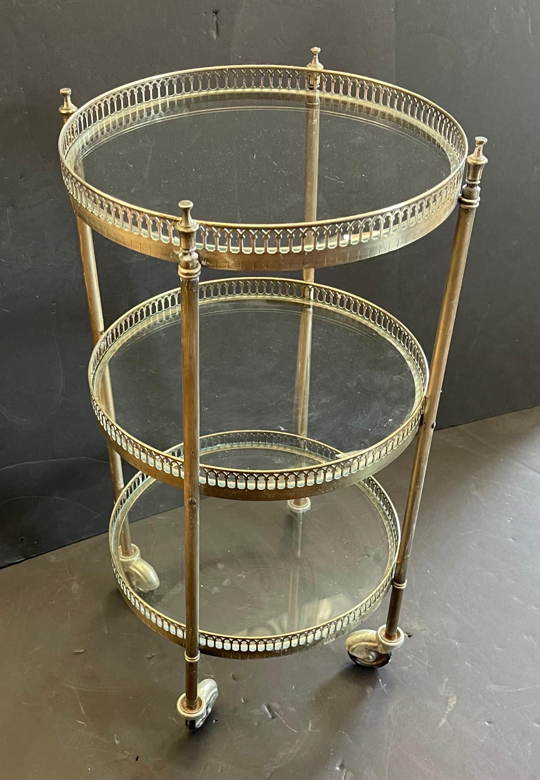 A wonderful French nickel silver plated & glass insert three-tier bar cart, round side table that is supported by Smooth Original Casters.

 