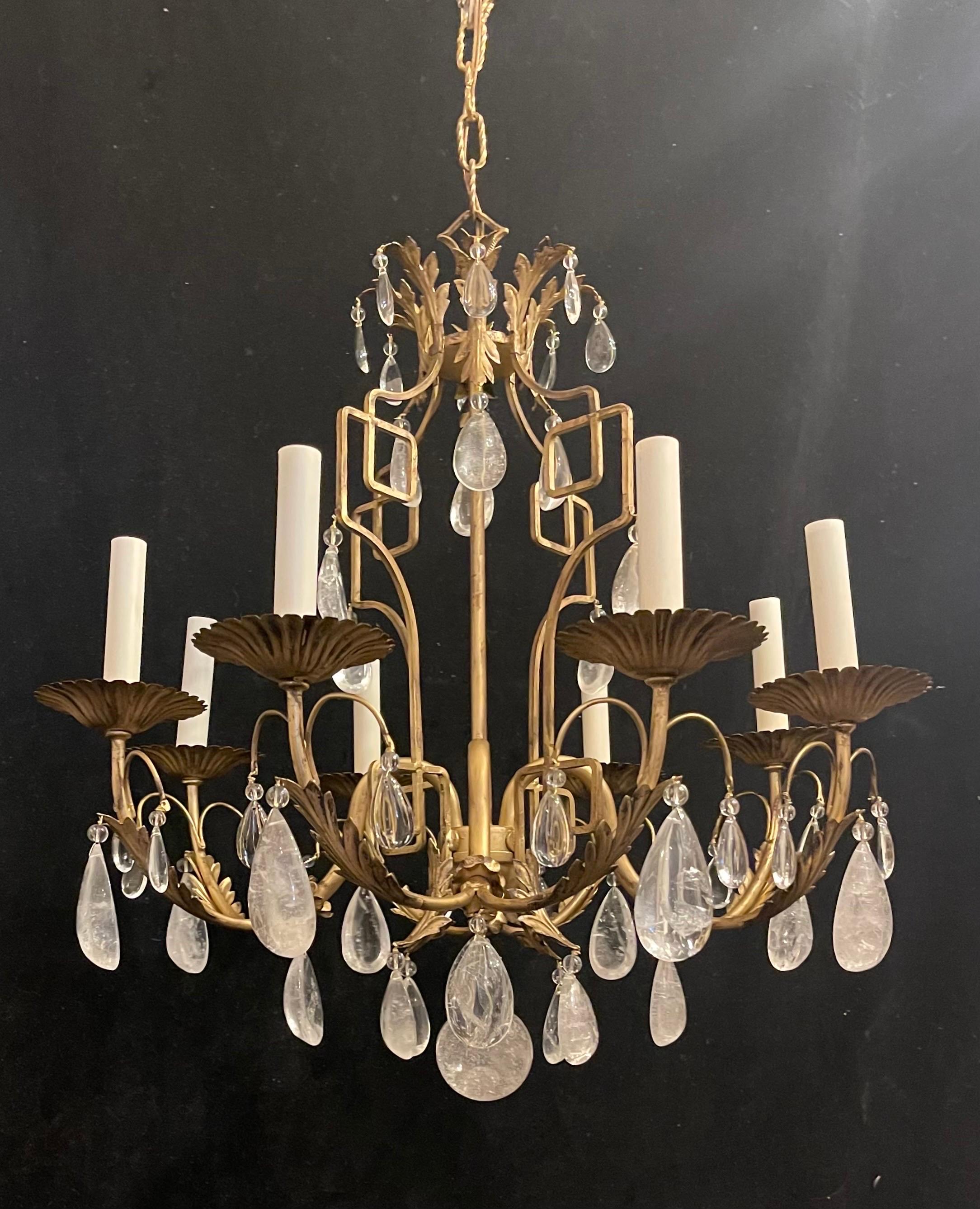 A wonderful french chinoiserie pagoda form with gold gilt iron and having rock crystal throughout, in the manner of Maison Bague's this chandelier has eight candelabra lights that have been rewired and comes with chain and canopy.
