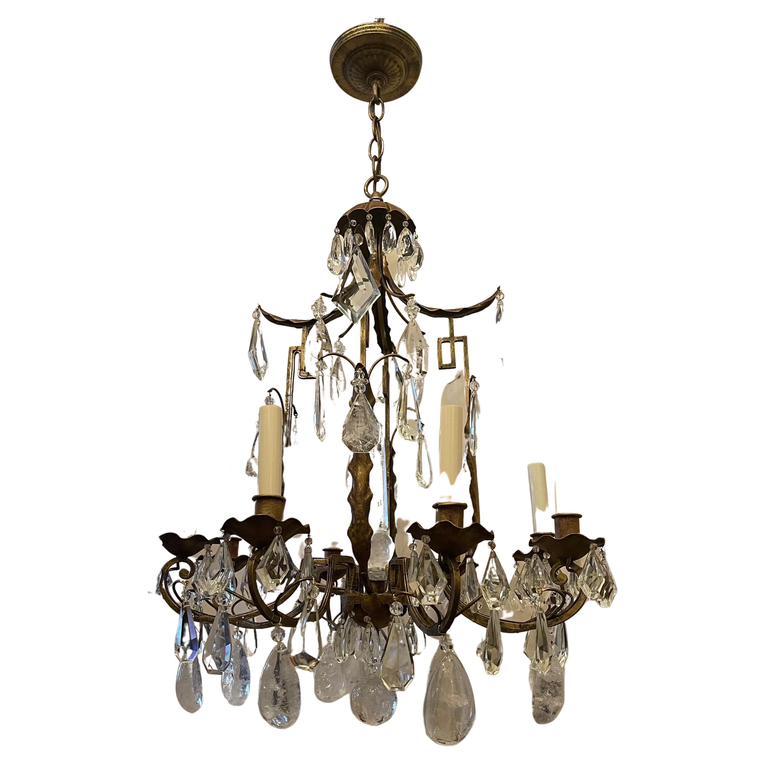 A wonderful French Pagoda form gold gilt with rock crystal & faceted crystal pendents in the manner of Maison Baguès chandelier having 8 candelabra lights and finished with a rock crystal ball on the bottom & a very impressive rock crystal center
