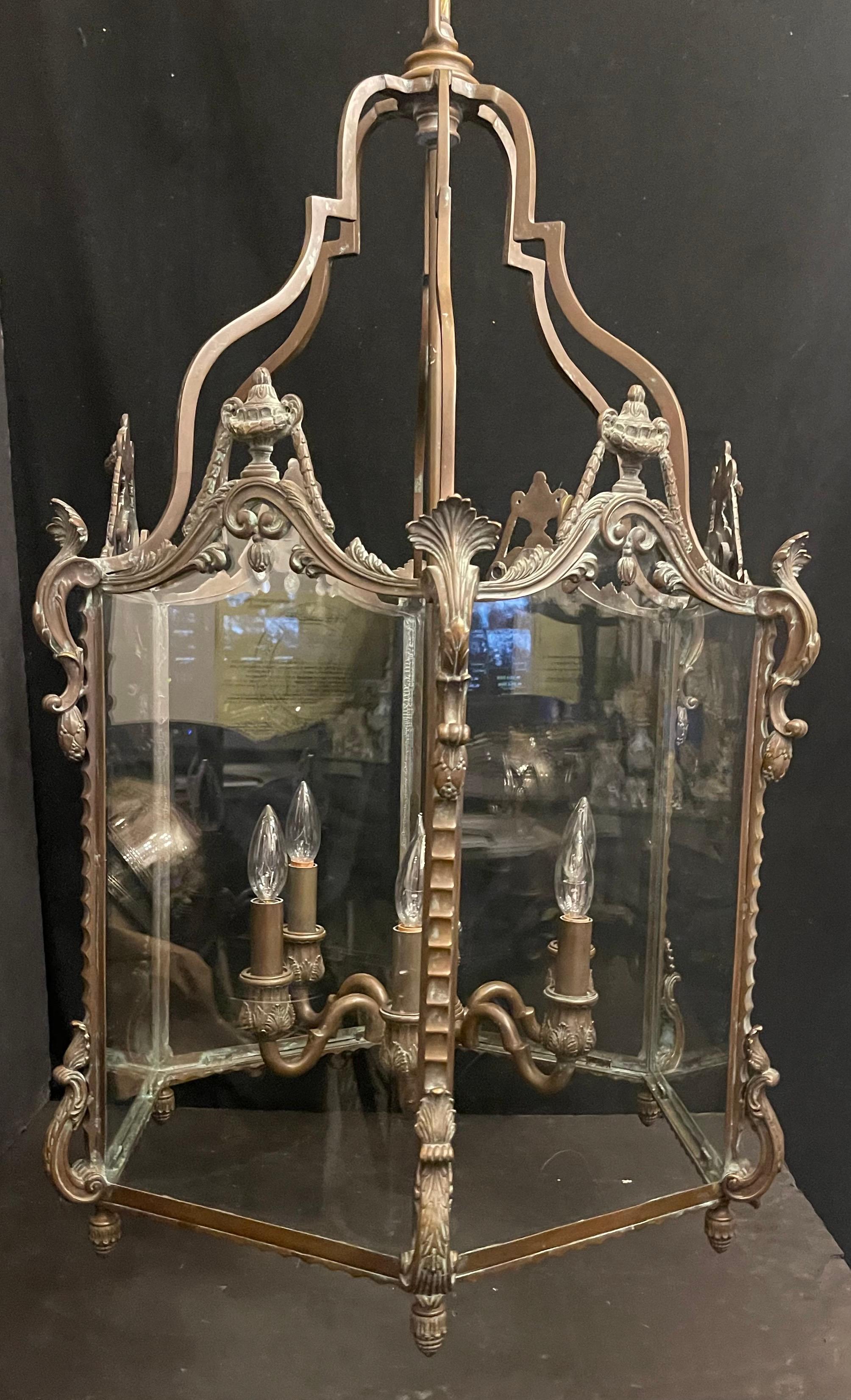 A Wonderful French Regency Style Patinated Bronze & 6 Panel Glass Large Louis XV Manner Lantern Fixture With 6 Candelabra Internal Light Cluster.
Updated Wiring And Comes Ready To Install With Chain, Canopy And Mounting Hardware.