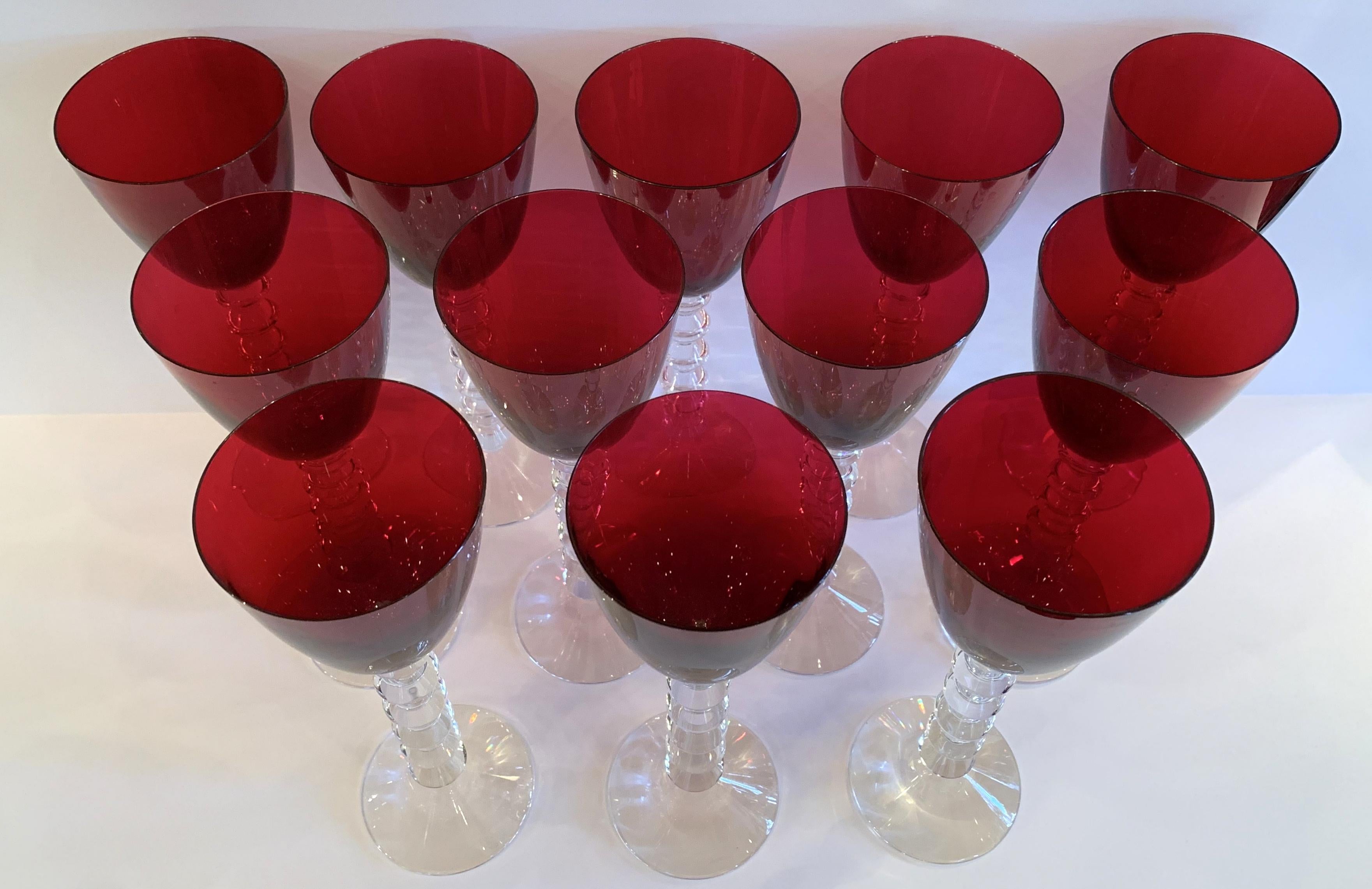 A wonderful French service set of 12 Baccarat VÉGA wine crystal glasses in a ruby red / rhine color. The sculpted stem in the form of entwined berlingots suggests a necklace of superb pearls, reminiscent of the famous Brancusi pillars.
Still