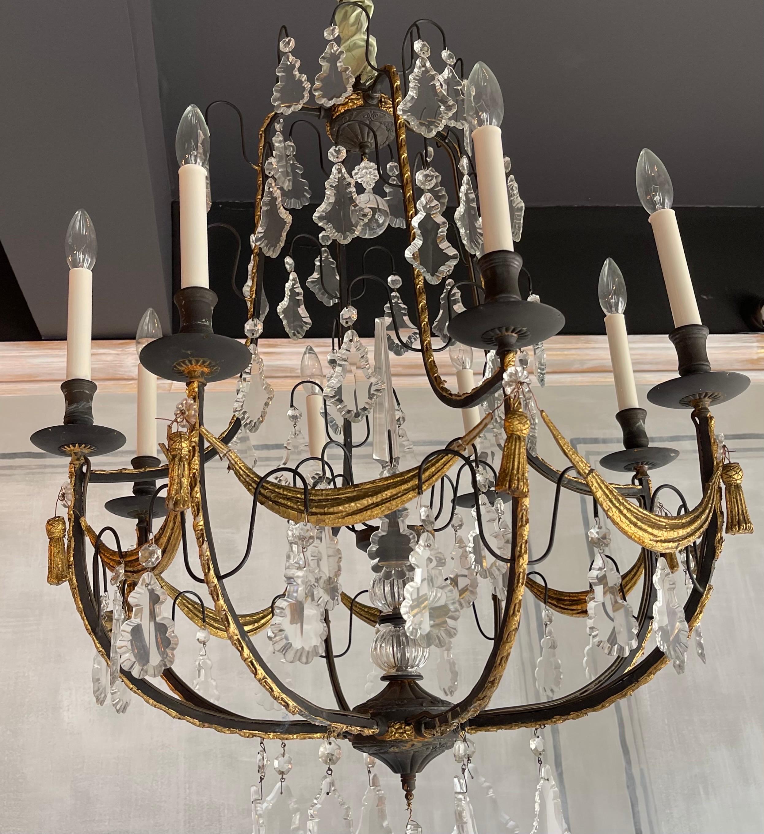 A wonderful French wrought iron & crystal Louis XV style chandelier with gilt gesso swags and tassels.
