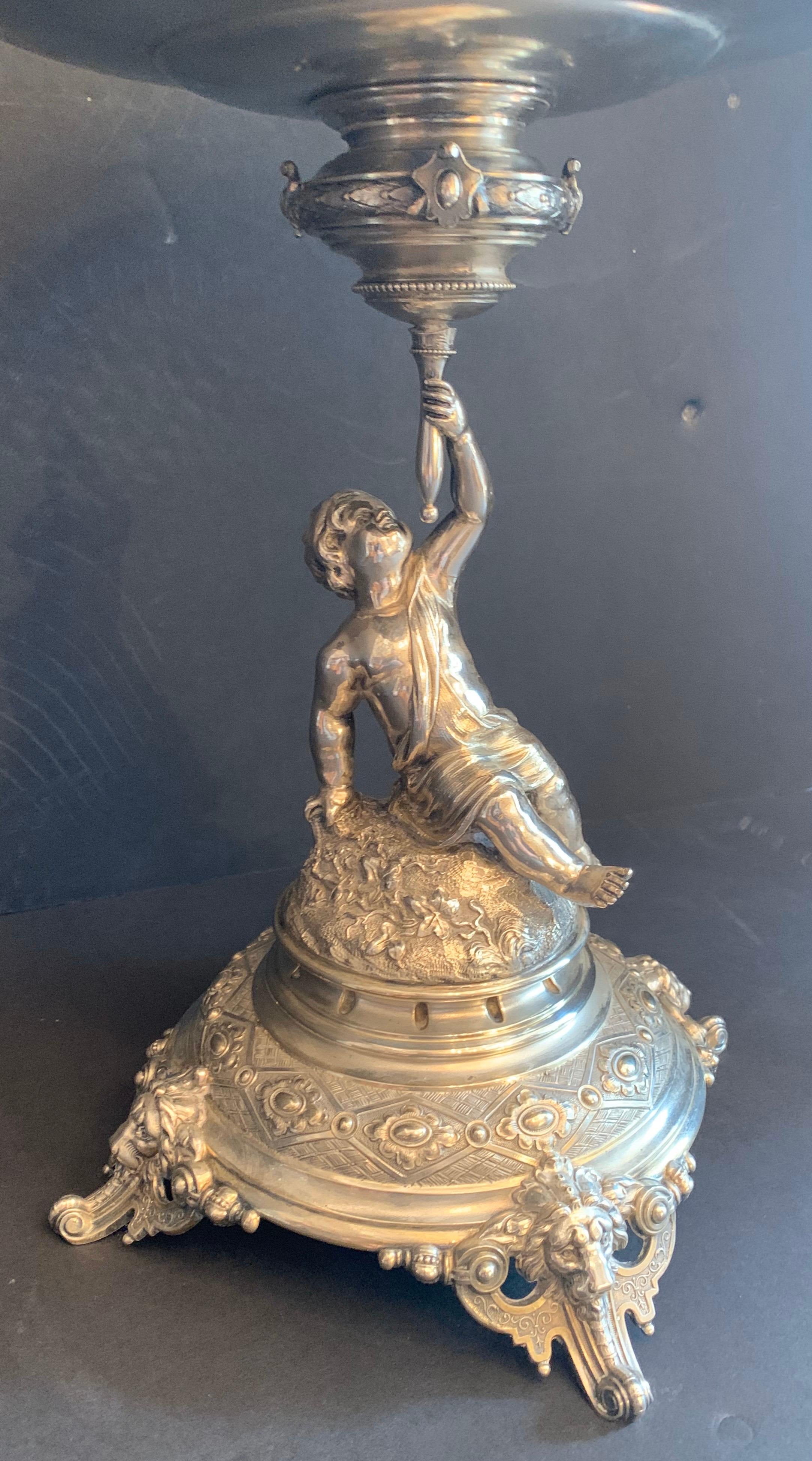 A wonderful german 800 sterling silver cherub figural centerpiece by Lazarus Posen, circa 1890
In the Rococo style, with a putti / cherub holding a filigree wreath swag and bow center bowl inset with a silver plated liner, below the cupid standing