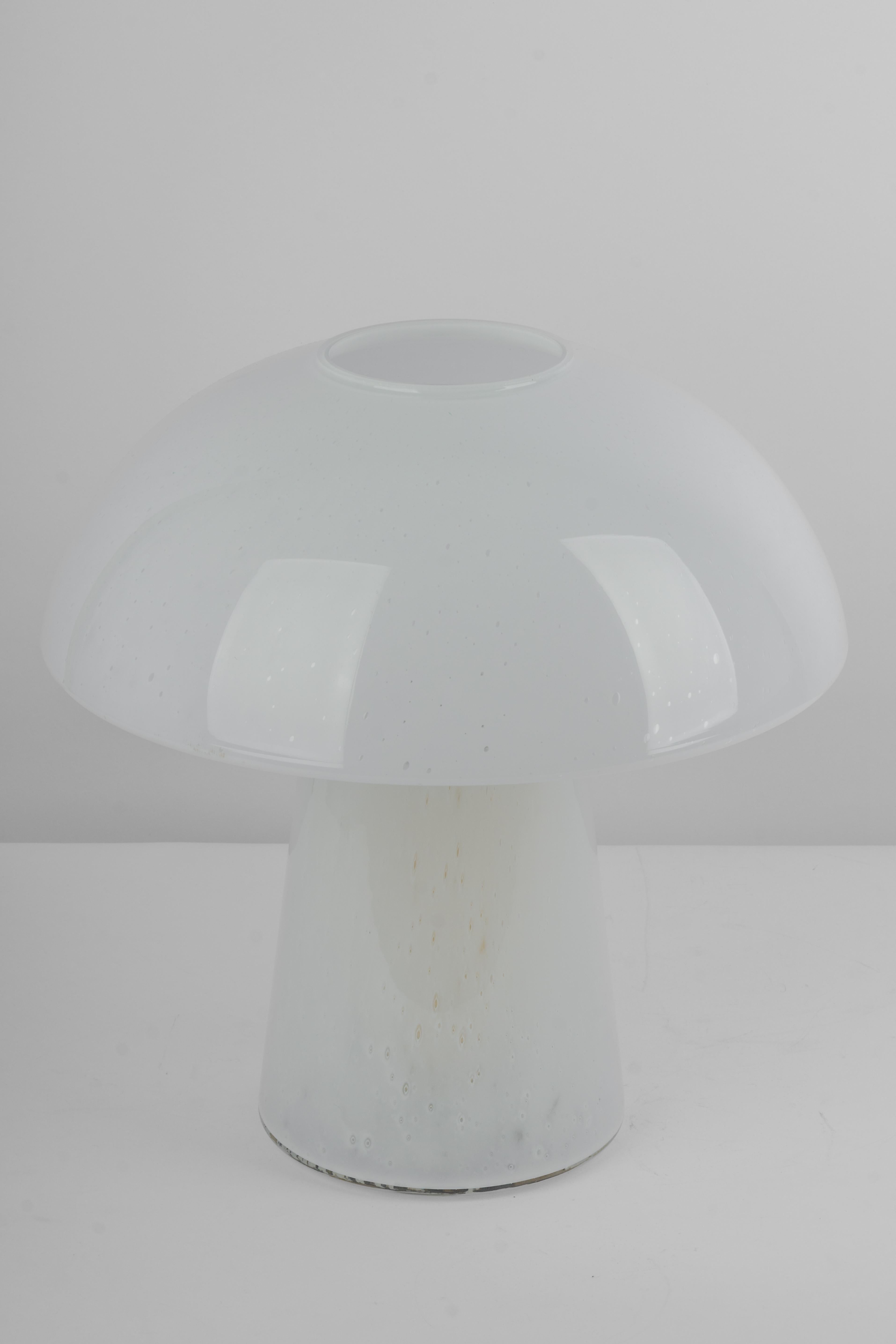 Wonderful mushroom table lamp by Limburg, Germany, 1970s. Made of a single piece.
Great glass body and its edgy quality contrast nicely with the smooth surface and shape of the mushroom. 

Measures: Large table lamp
Height 37 cm // 14.5 in.
Diameter