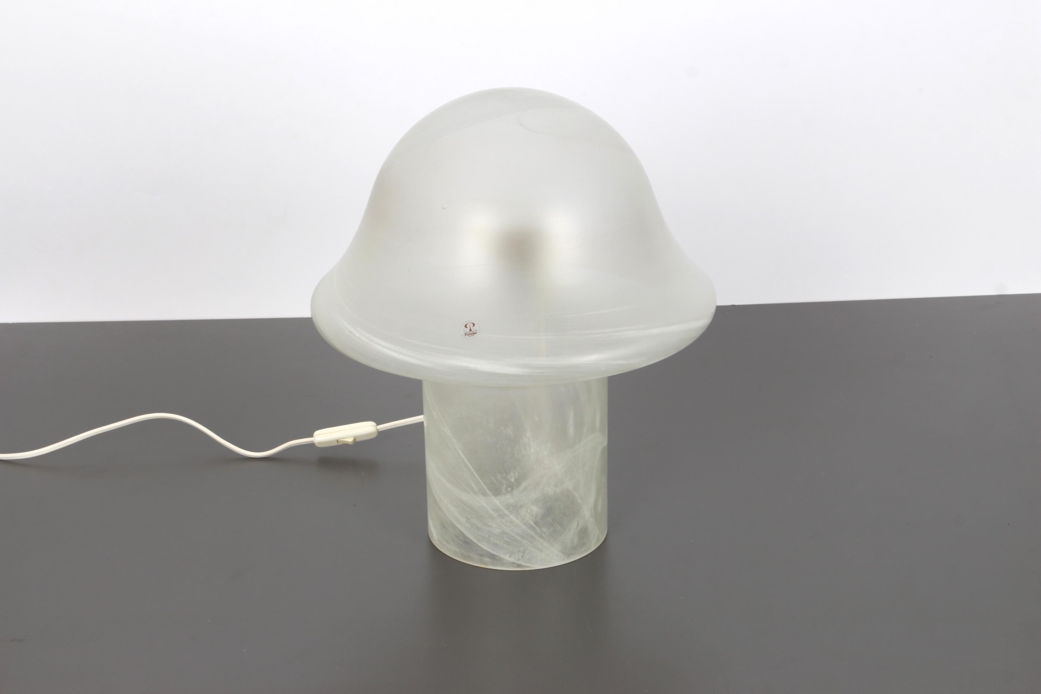 Wonderful mushroom table lamp by Peill & Putzler, Germany, 1970s. Made of a single piece.
Great glass body and its edgy quality contrasts nicely with the smooth surface and shape of the mushroom. 

Measures: Large table lamp
Height 37 cm, 14.5