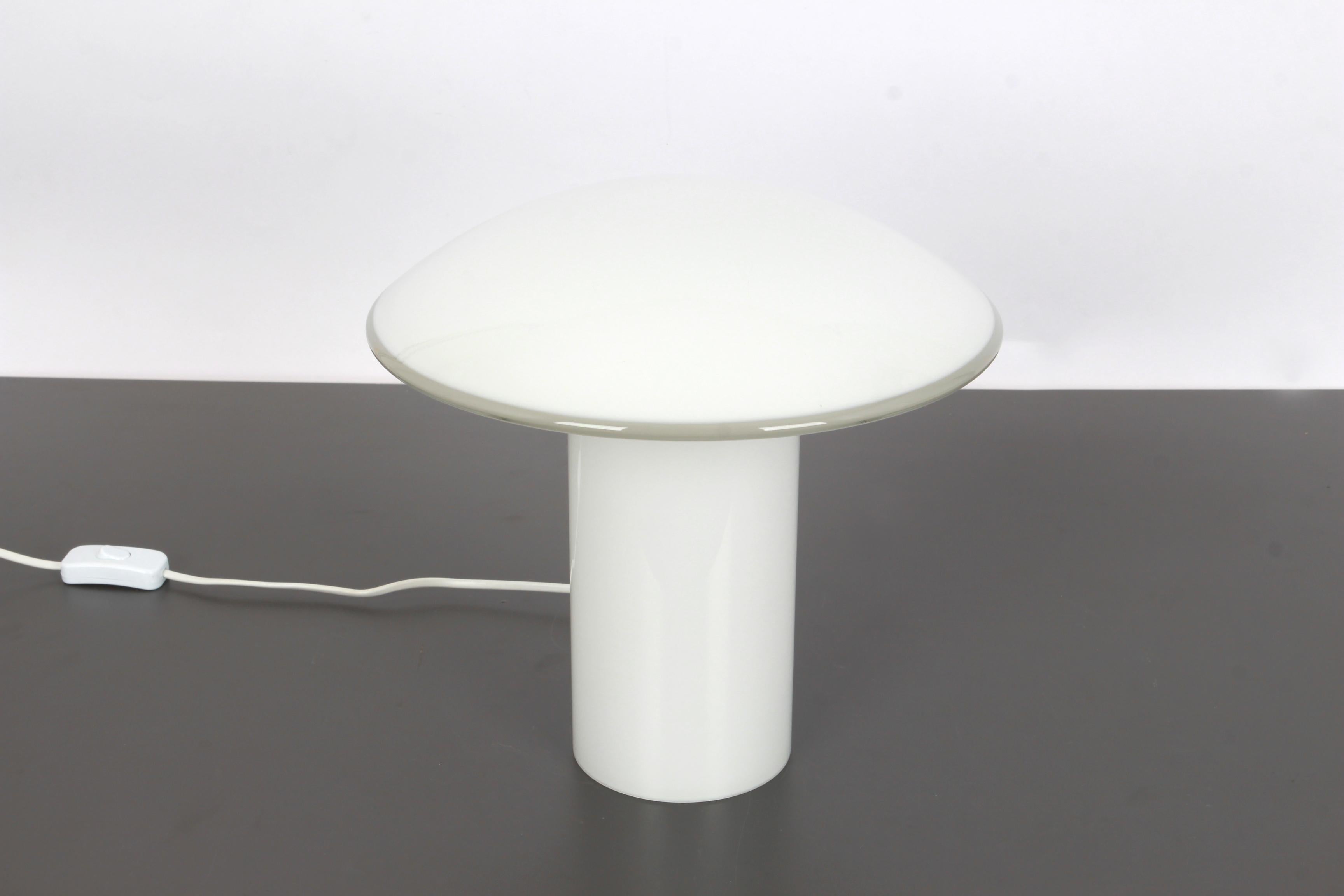 Wonderful mushroom table lamp by Peill & Putzler, Germany, 1970s. Made of a single piece.
Great glass body and its edgy quality contrast nicely with the smooth surface and shape of the mushroom. 

Large table lamp:
Height 30 cm //11.8