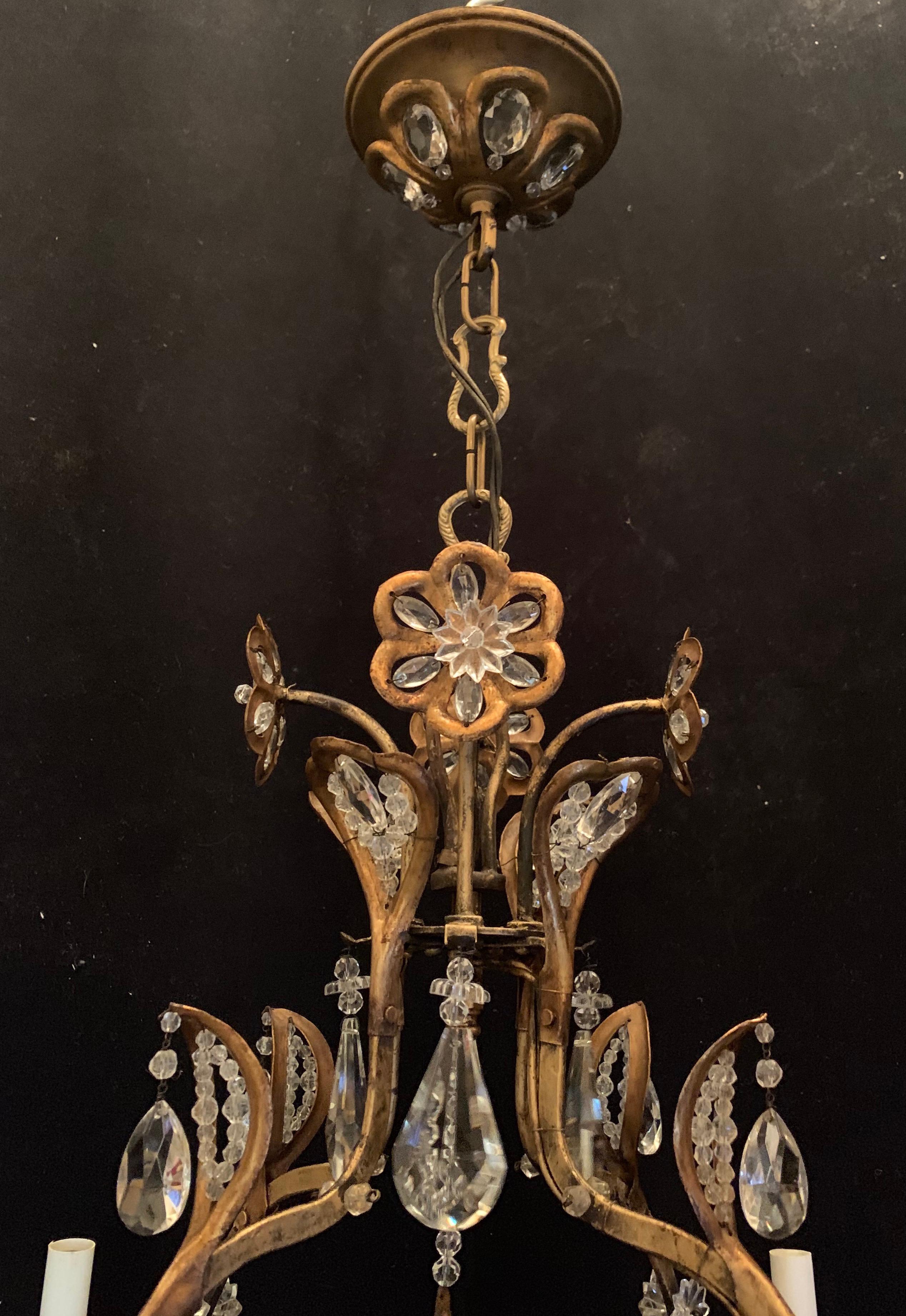 A wonderful gold gilt iron Baguès style crystal beaded and flower motif 8 candelabra light fixture chandelier.