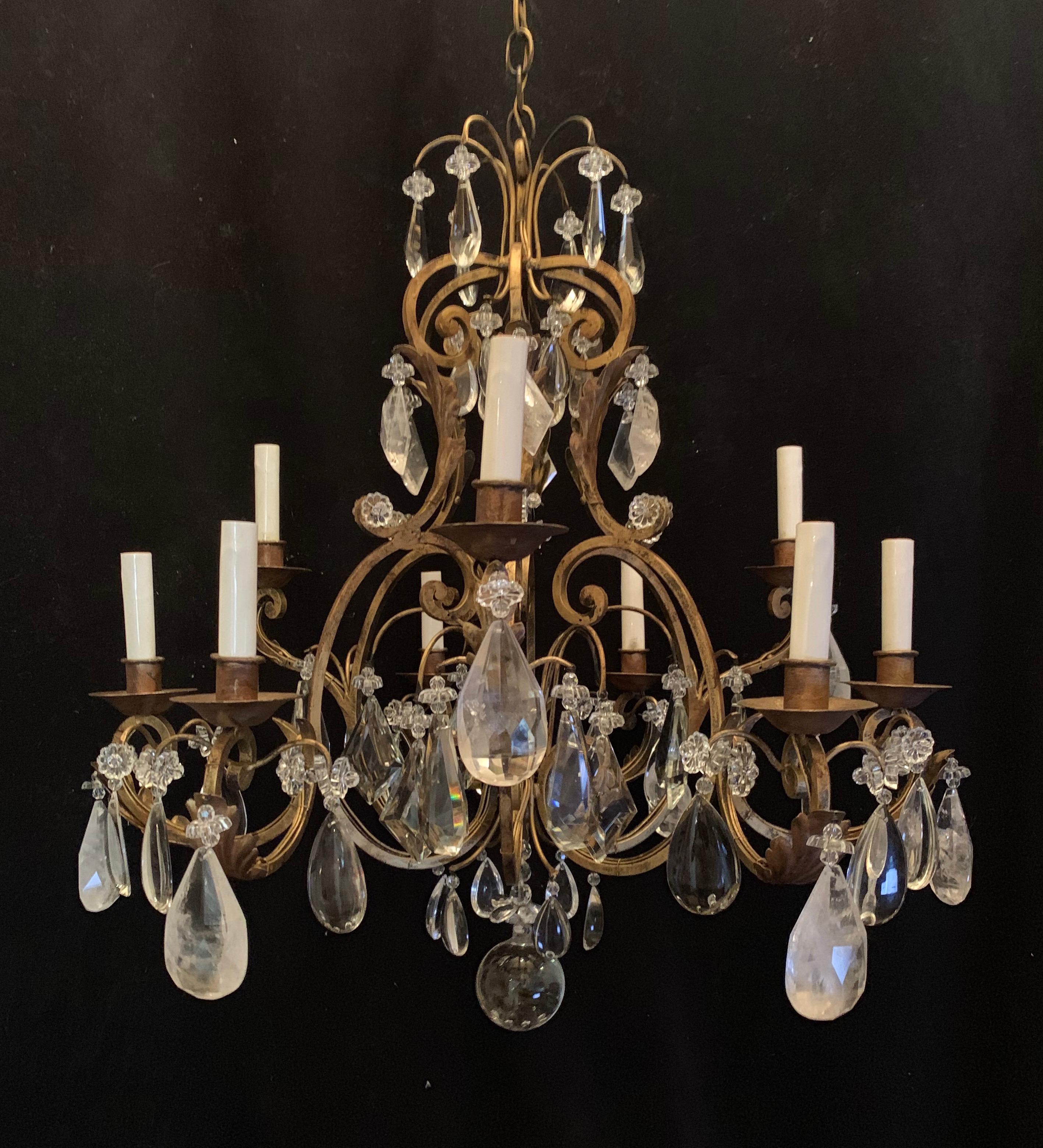 A wonderful gold gilt iron Baguès style rock crystal and beaded flower 9 candelabra light chandelier.