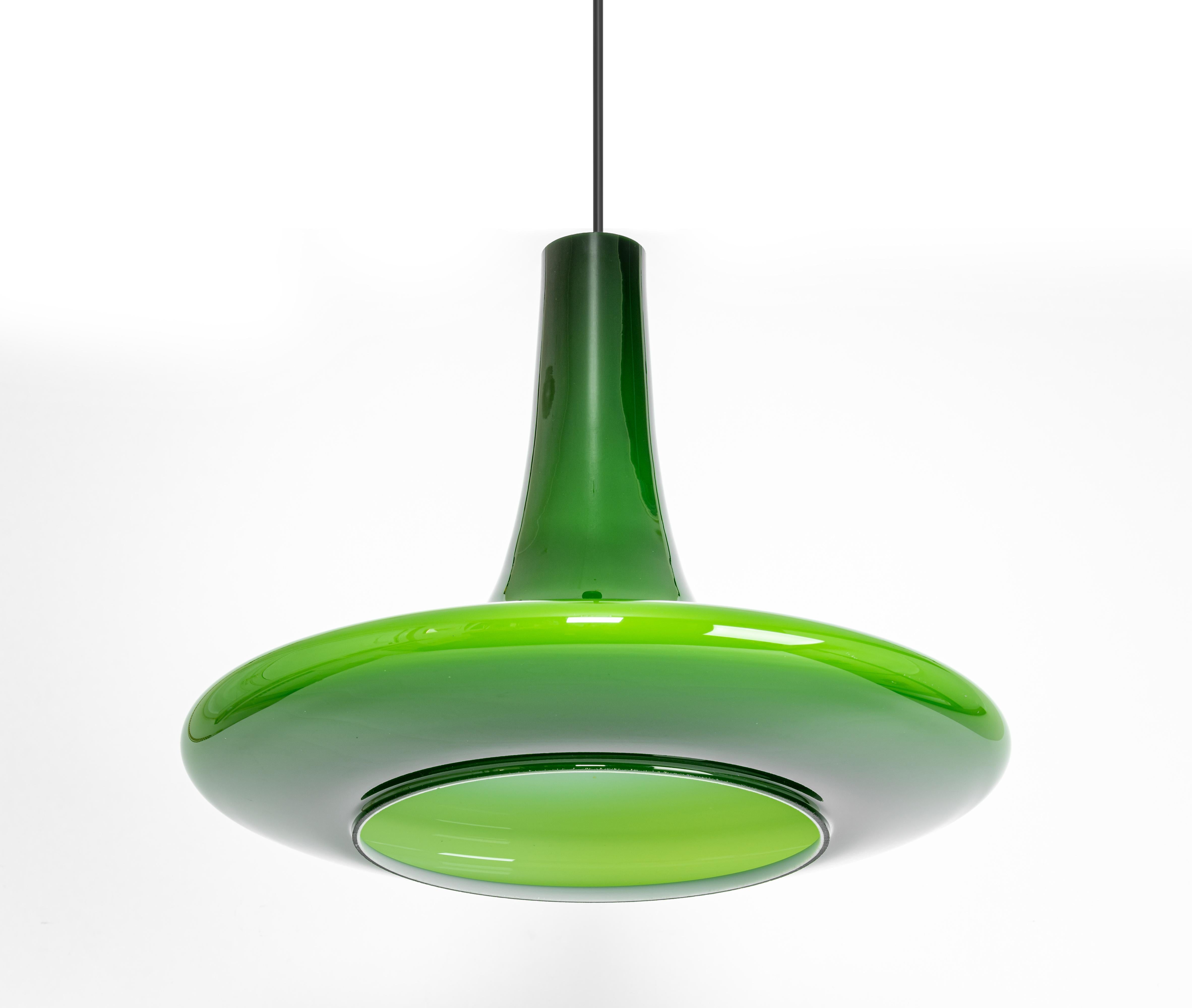 A special form of opal glass pendant designed by Koch & Lowy for Peill & Putzler, manufactured in Germany, circa 1970s.
Jade color cased on opal glass.


Sockets: One x E27 standard bulb. (150 W max).
Drop rod can be adjusted as required, free of