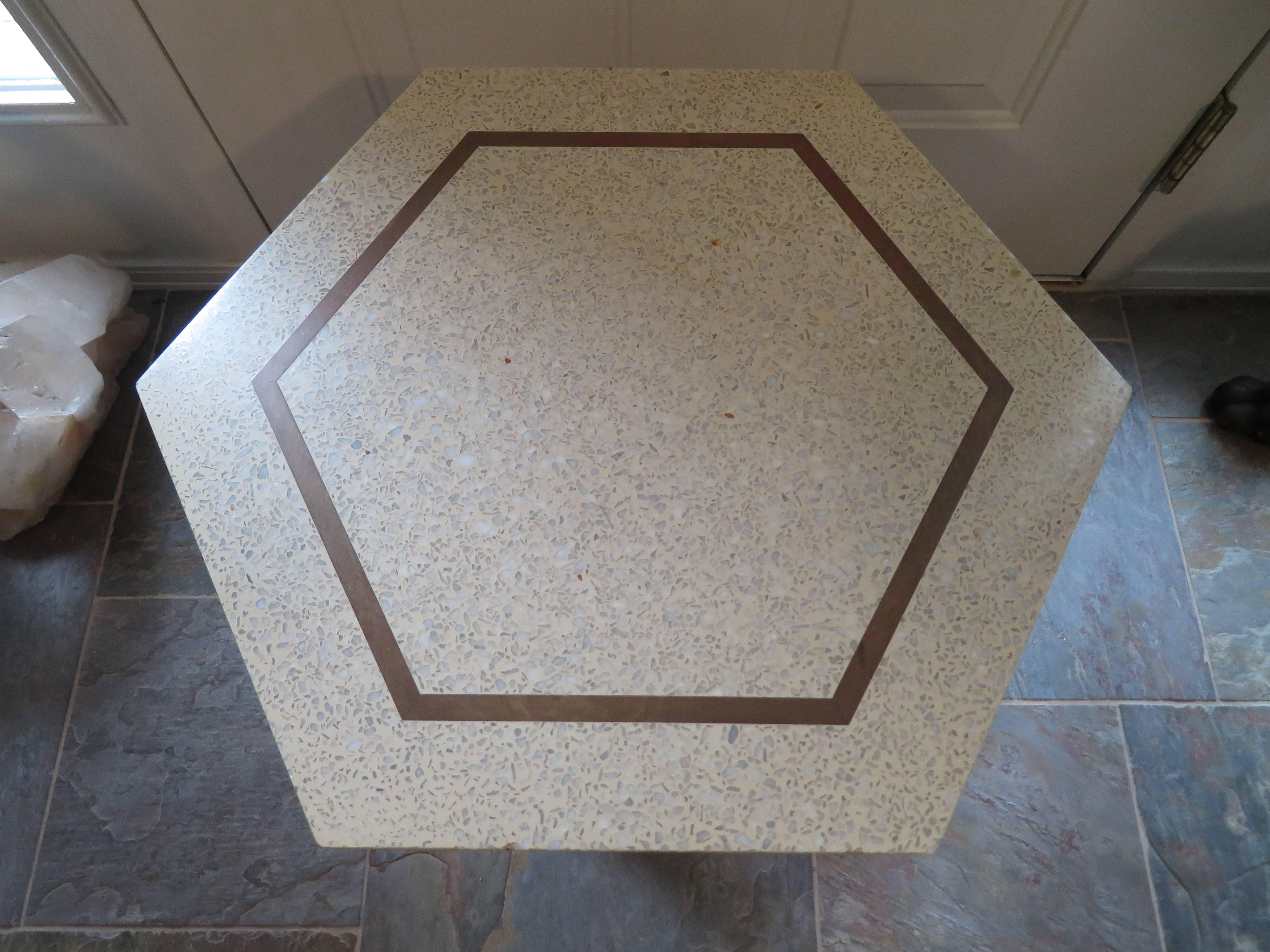 Wonderful three-legged Harvey Probber side or end table with original hexagonal terrazzo top with inlaid brass. Sculpted bleached mahogany legs with bleached mahogany supports. We do have a pair available also if your looking for a set of three or