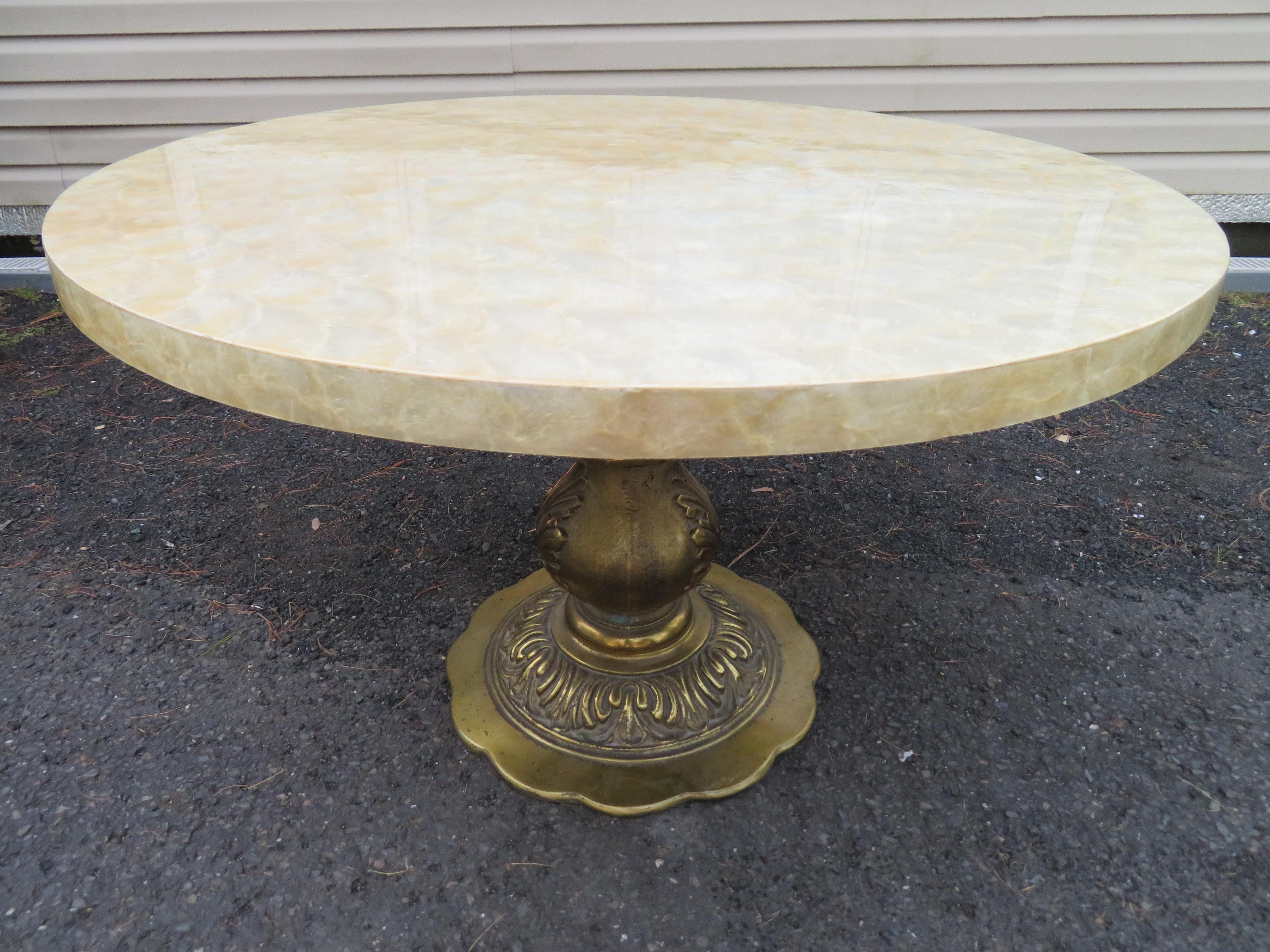 Wonderful Hollywood regency Capiz shell center table. We just love the capiz shell top with the ornate brass pedestal base. This table measures 26