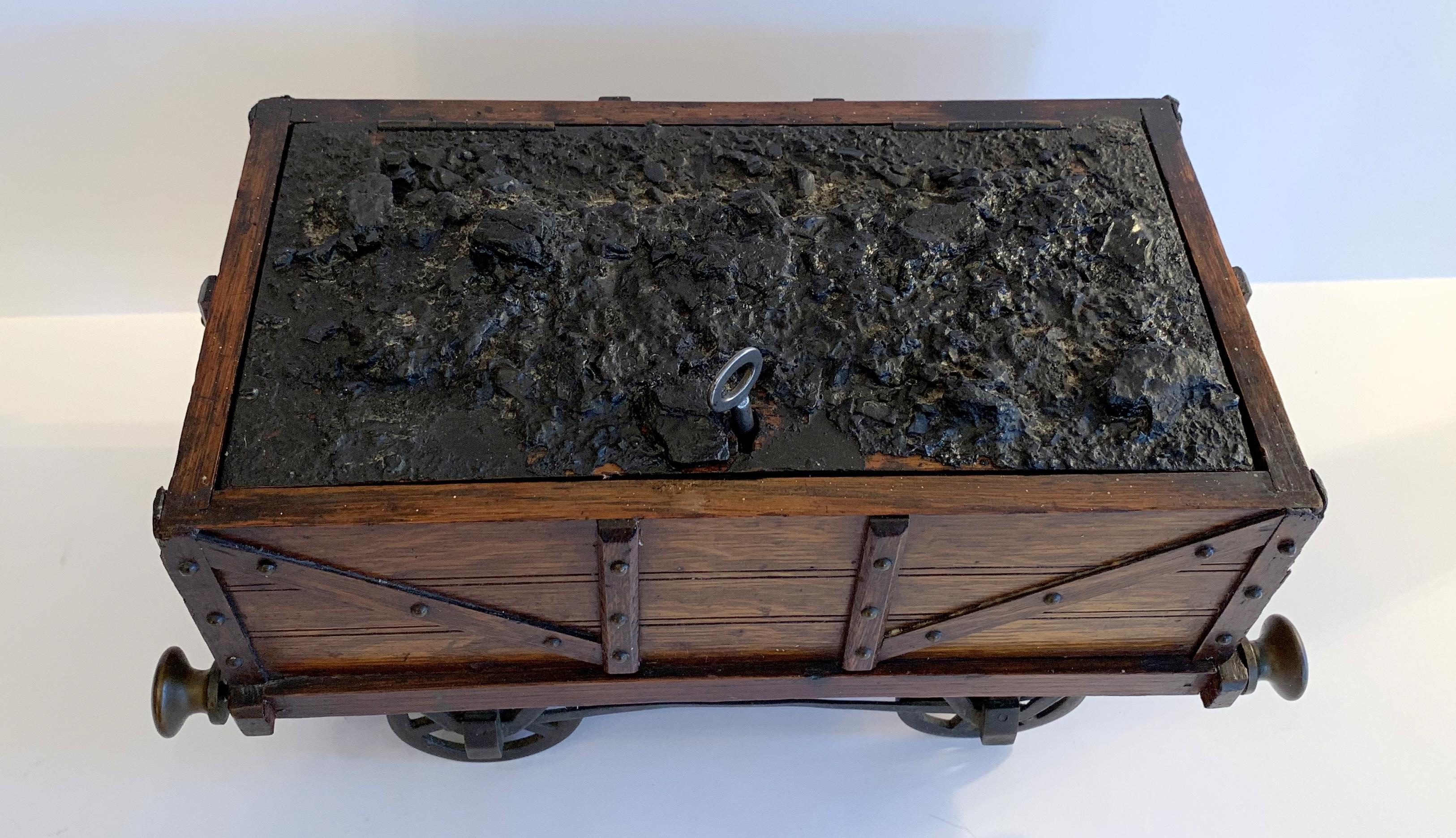 A wonderful oak and tin and bronze fitting humidor in the form of a railway coal wagon / train carriage titled 
