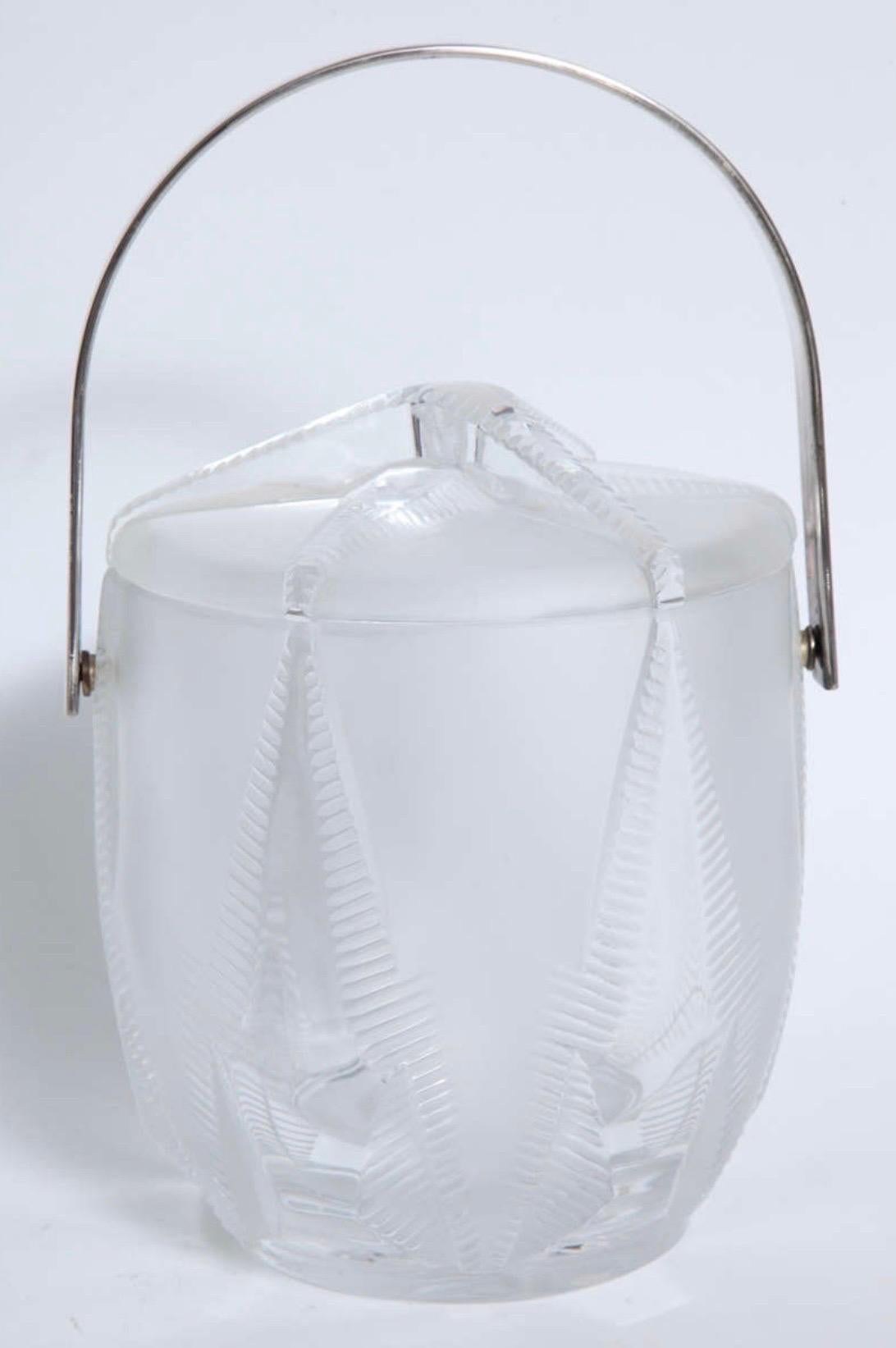 A fantastic Thermidor Lalique lidded ice bucket with nickel-plated handle and raised starfish design. The liner is removable a glass container can serve as a champagne or wine bucket.
Signed Lalique France