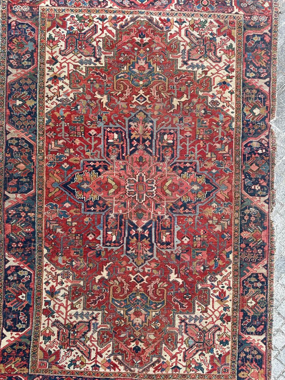 Discover a magnificent antique Heriz rug, boasting exquisite geometric and decorative patterns in rich, natural hues. This masterpiece is meticulously hand-knotted with sumptuous wool velvet on a cotton foundation. 

At its center, a star-shaped