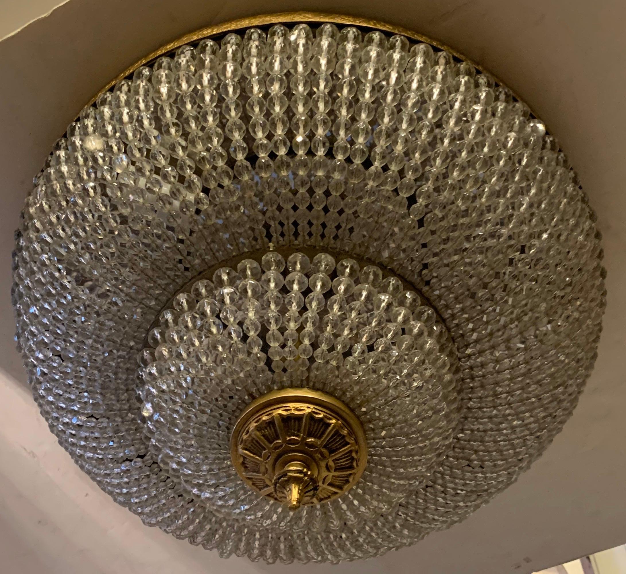 A wonderful large beaded crystal basket form brass two-tier light fixture with new wiring and 3 candelabra sockets.