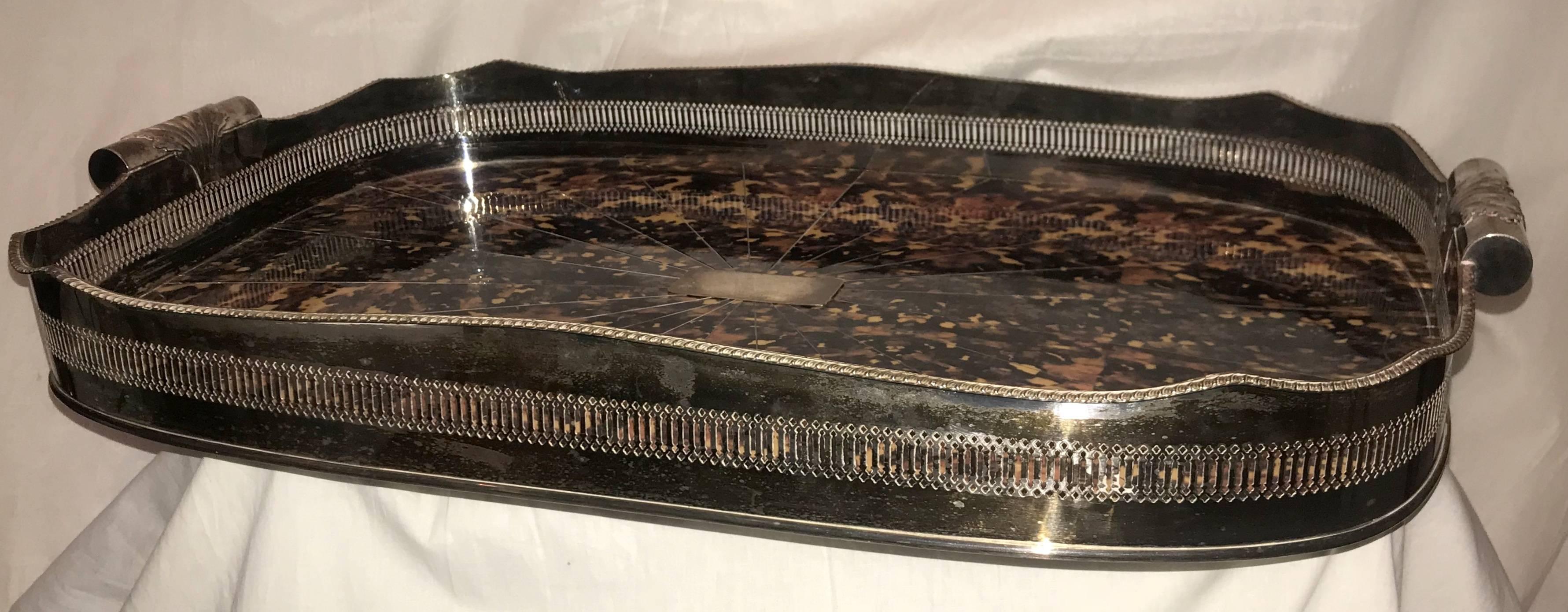 A wonderful large English faux tortoise shell silver plated serving gallery tray, great for tea, coffee, or cocktails or just to sit on an ottoman. This beautiful serving piece has a prominent pierced and scalloped gallery and tooled with intricate