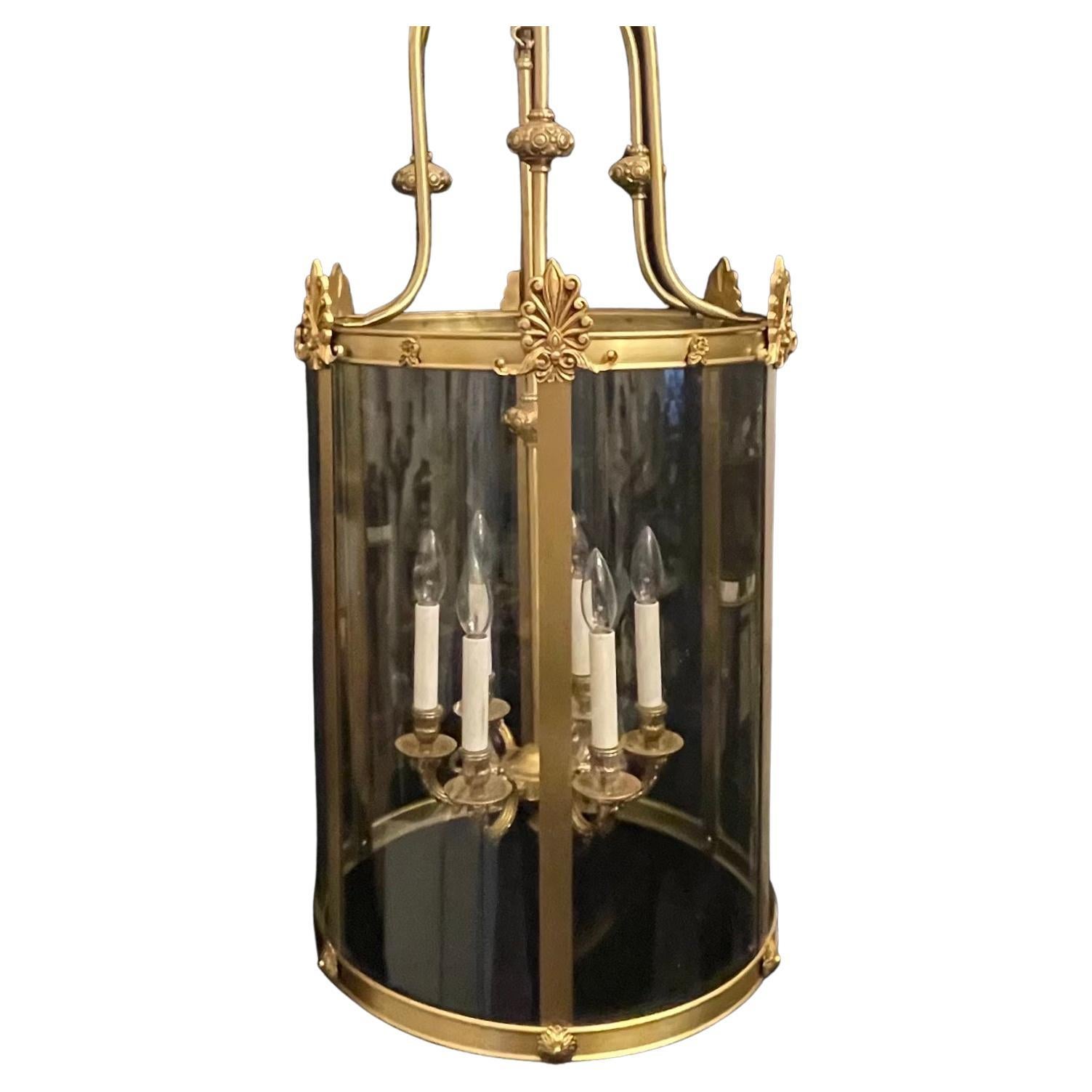 A wonderful large French bronze Regency / Empire style curved glass panel lantern light fixture with 6 candelabra lights.