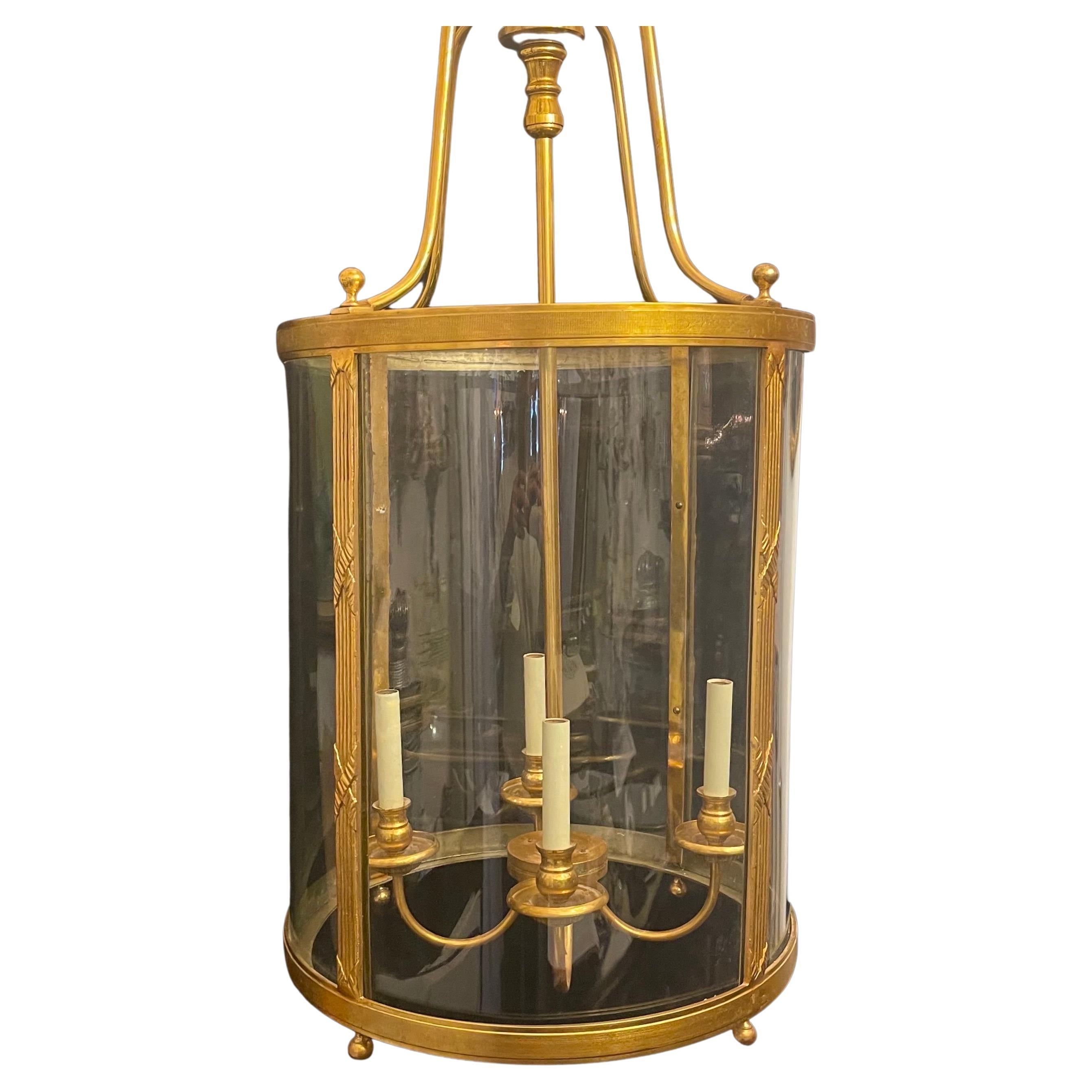 A wonderful large french bronze read & x pattern Regency / Empire style curved glass panel lantern fixture with 4 candelabra lights.
