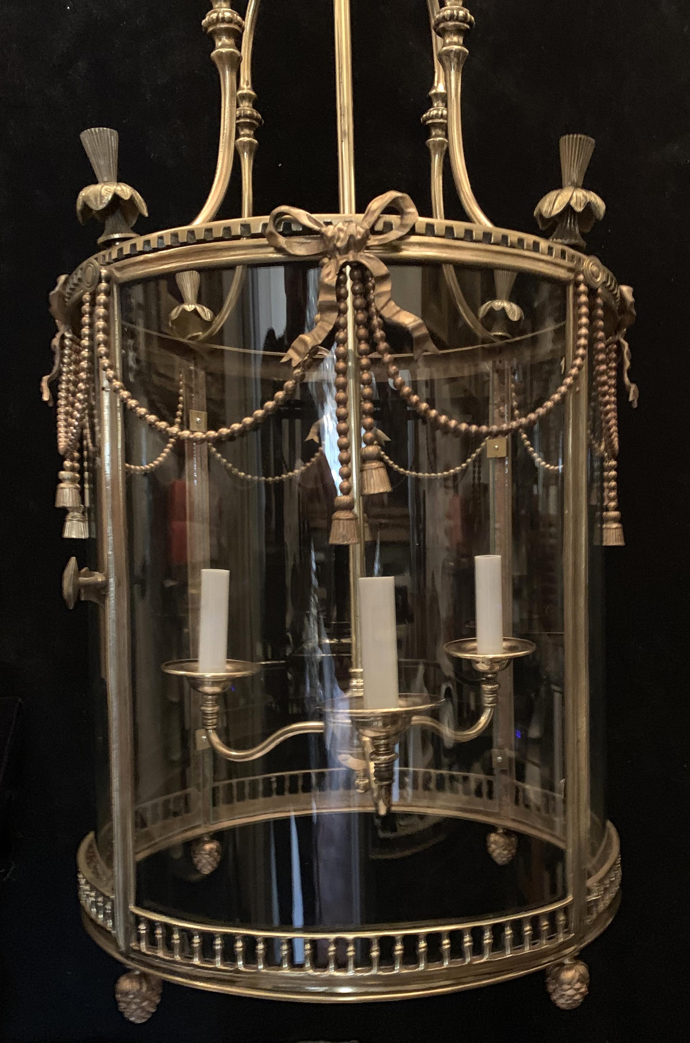 A wonderful large French ormolu gilt bronze bow, ribbon, tassel, swags and finials three-light lantern fixture. Completely rewired with new sockets and wiring.