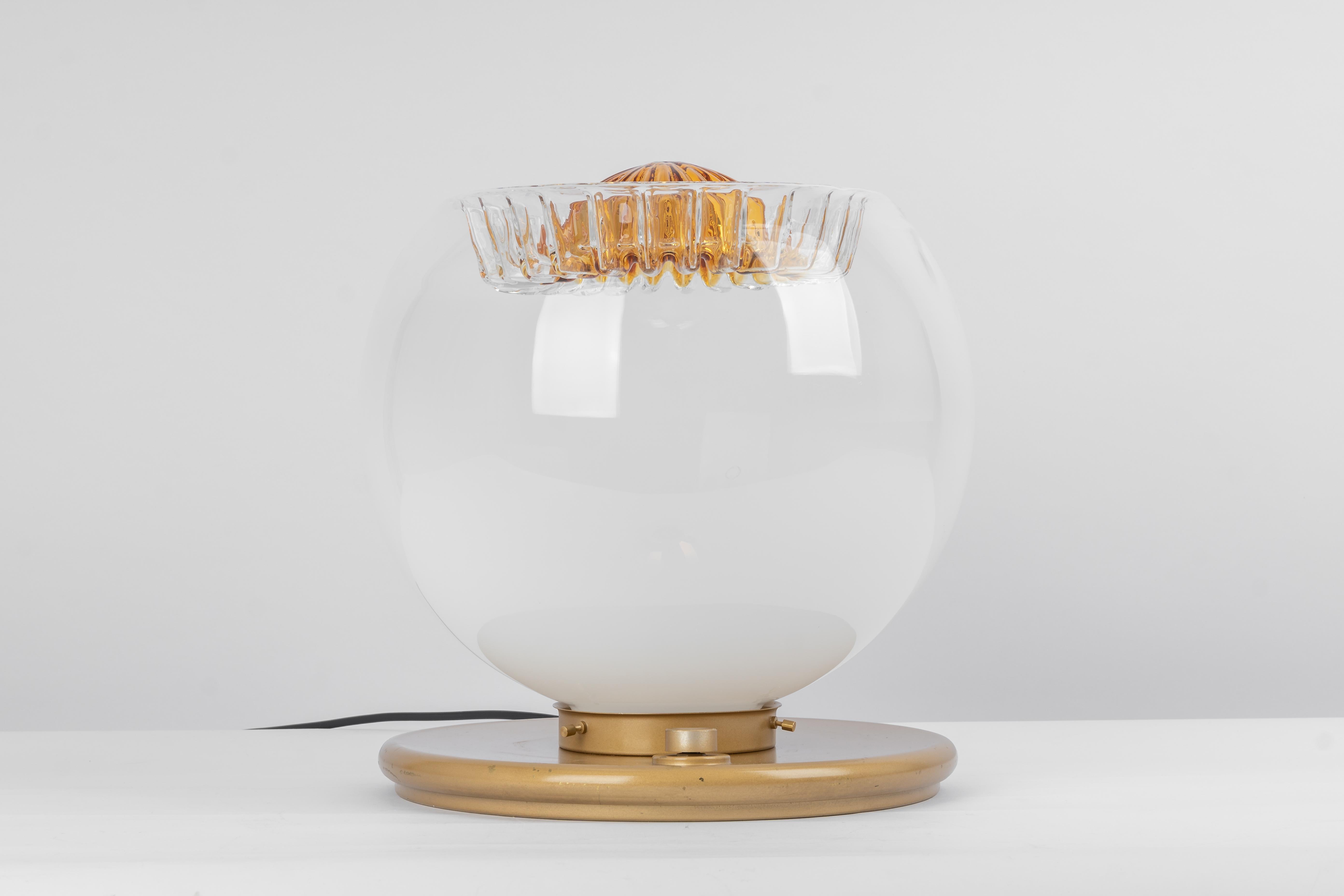 Wonderful table lamp Italy, 1970s. 
Great glass body and wonderful light effect.

Measures: Large table lamp
Height 37 cm // 14.5 in.
Diameter 35 cm // 13.7 in.
   

Socket: 1 x E27 standard bulb.( up to 100 W)
Light bulbs are not included.