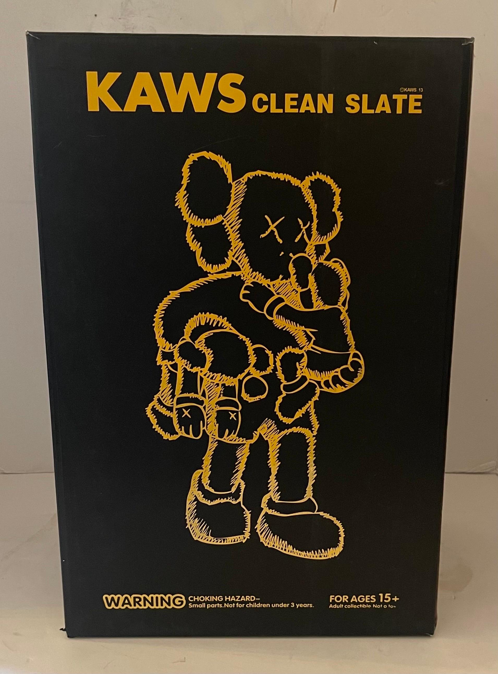A wonderful large KAWS clean slate black varnished vinyl original fake 2013 figure holding two children in original box and plastic insert sleeve.